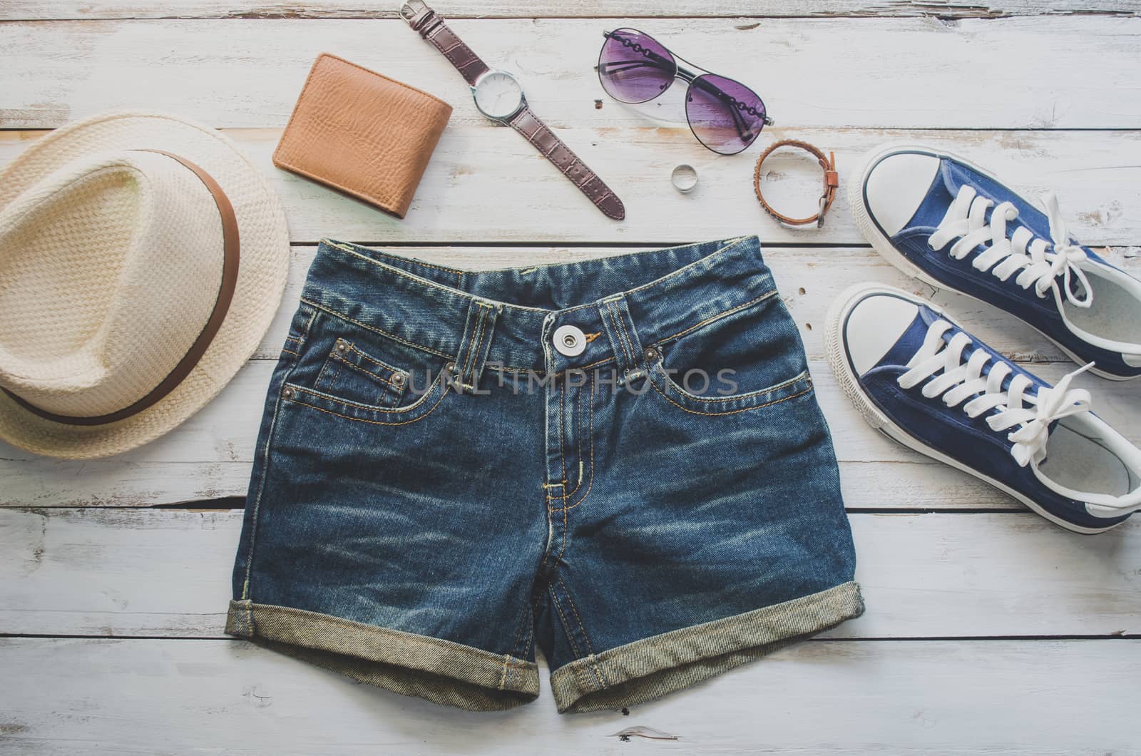 clothing for women, placed on a wooden floor.