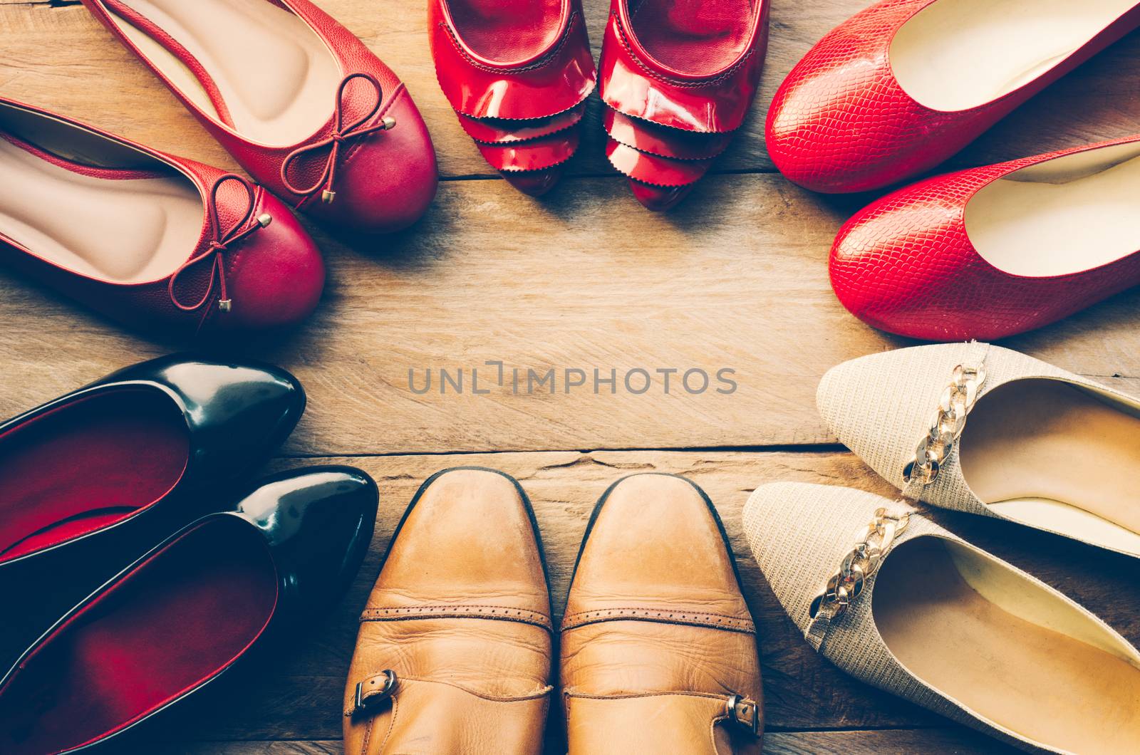 One man's shoes with many women shoes on the wood. concept cheater for men 
