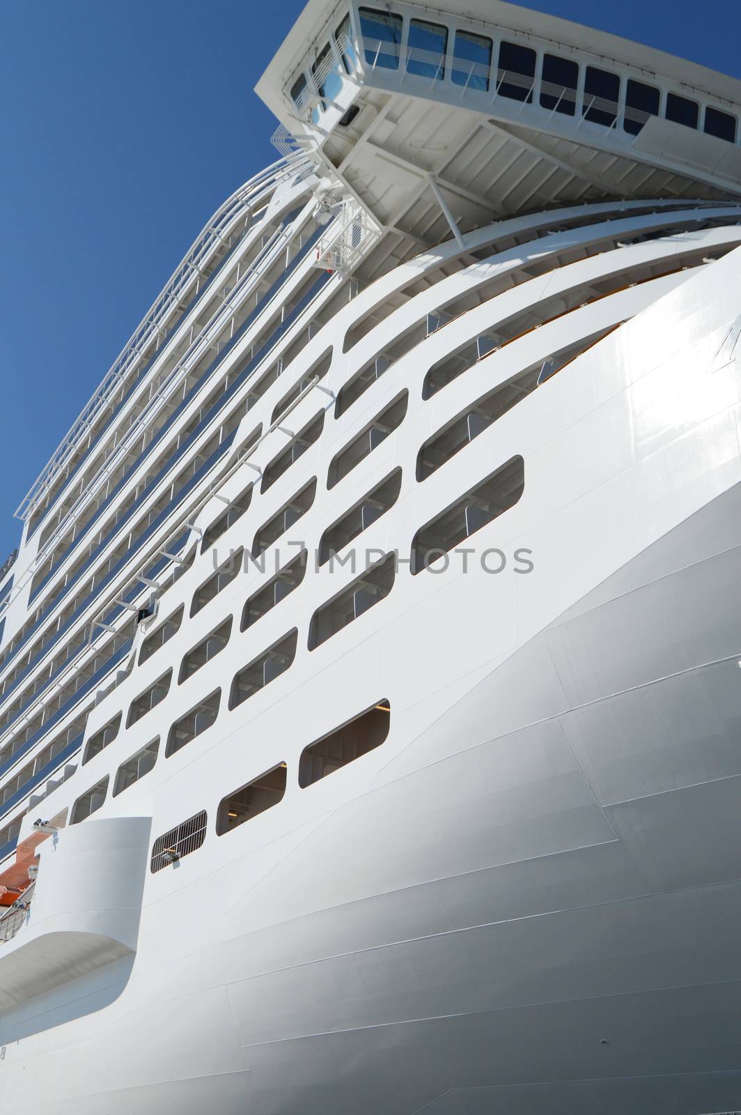 Luxury white cruise ship on blue sky background close-up by claire_lucia