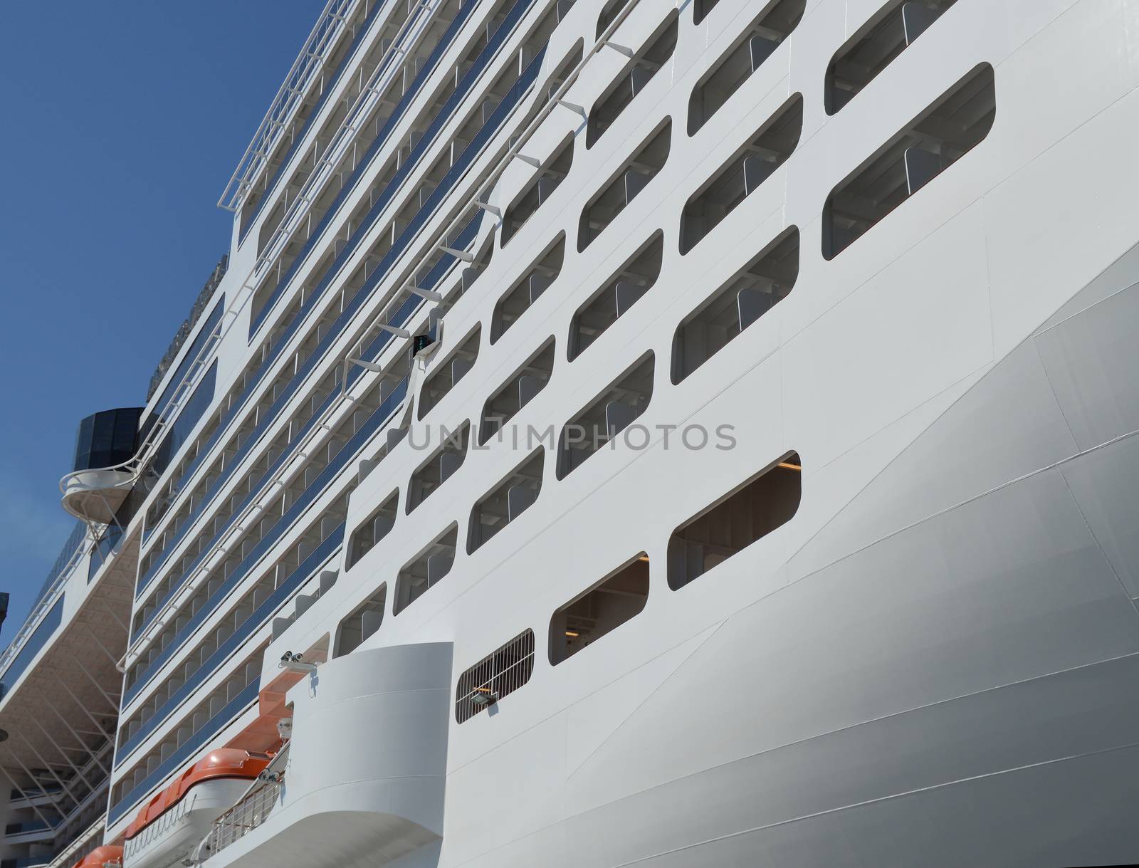Luxury white cruise ship on blue sky background close-up by claire_lucia