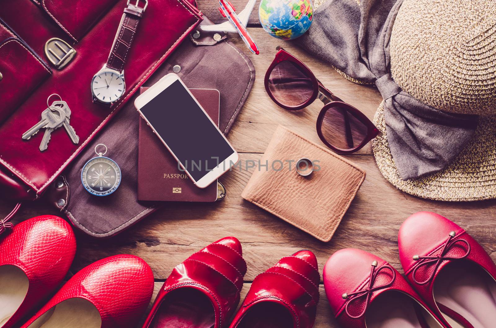 Clothing and accessories for women, placed on a wooden floor.- c by photobyphotoboy
