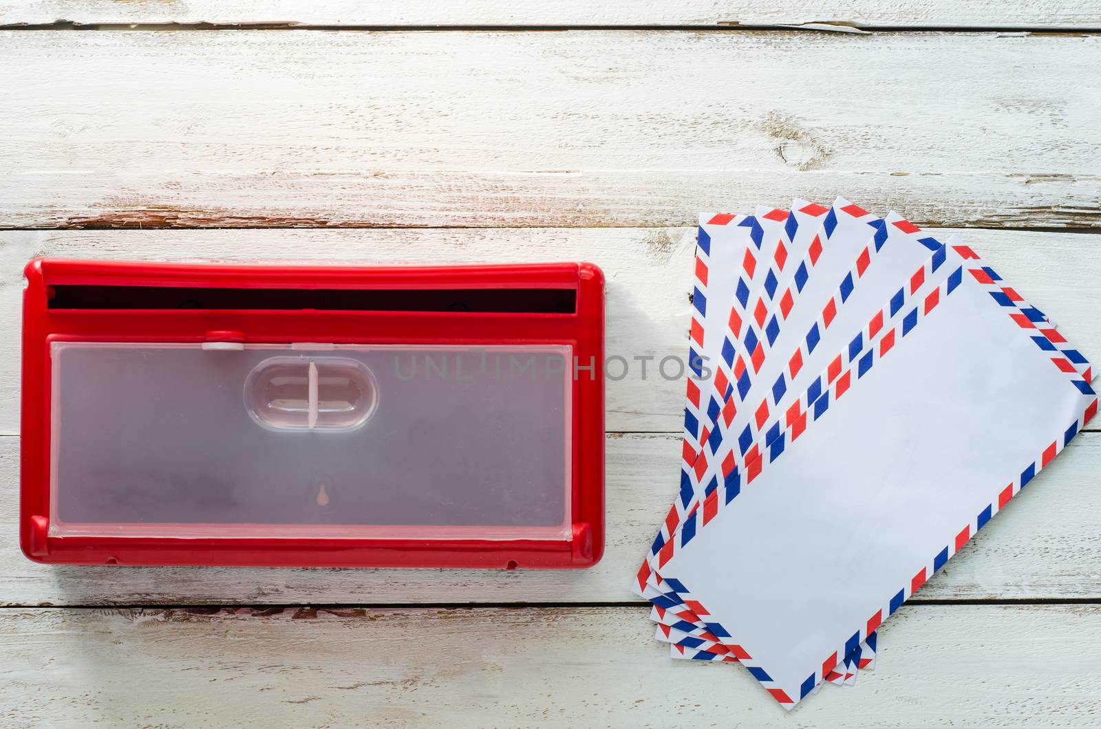 Red envelope mailboxes are placed on a wooden floor.