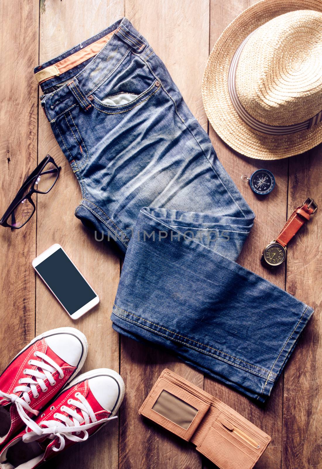 Clothing and accessories for travel on wooden floor - concept lifestyle