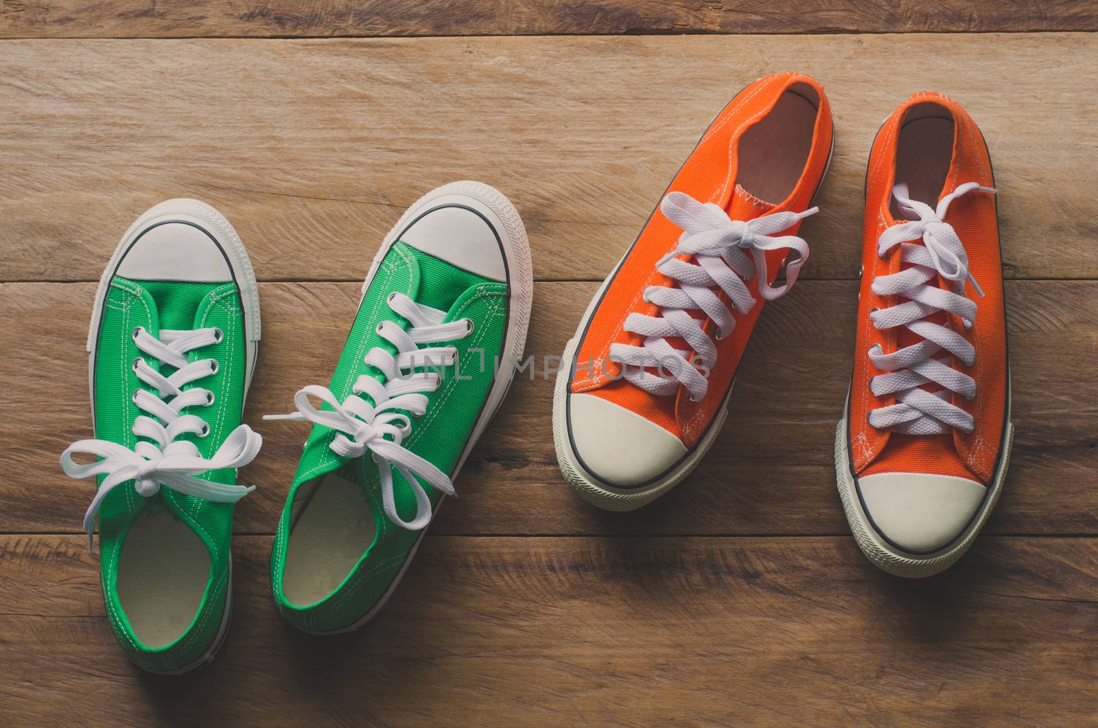 Red and Green sneakers on wooden floors - lifestyle by photobyphotoboy