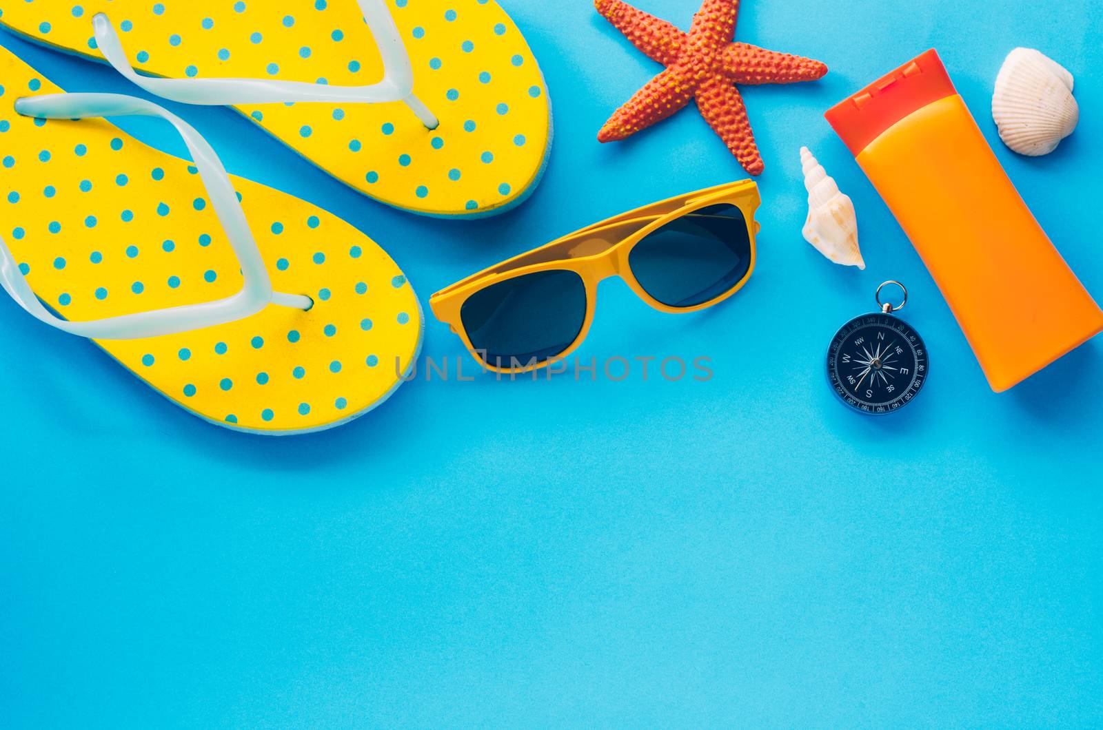 Clothing accessories for summer on blue paper floor - concept li by photobyphotoboy