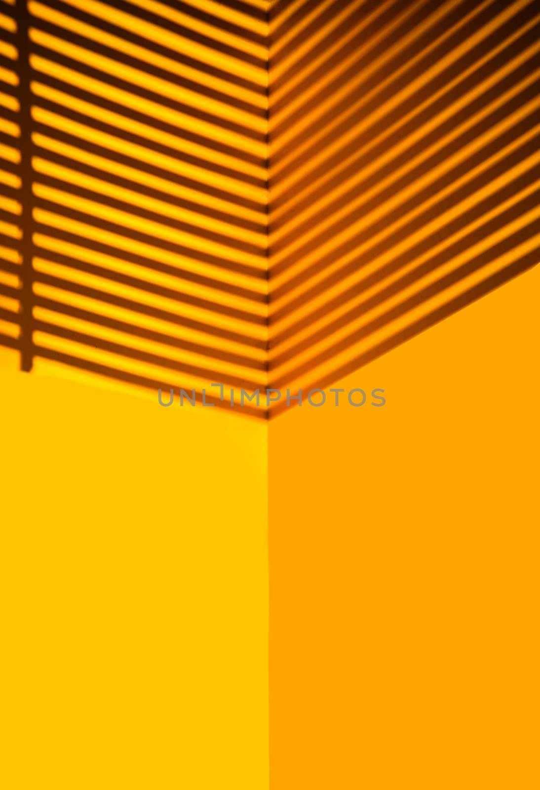 Yellow wall with black shadow on top by photobyphotoboy