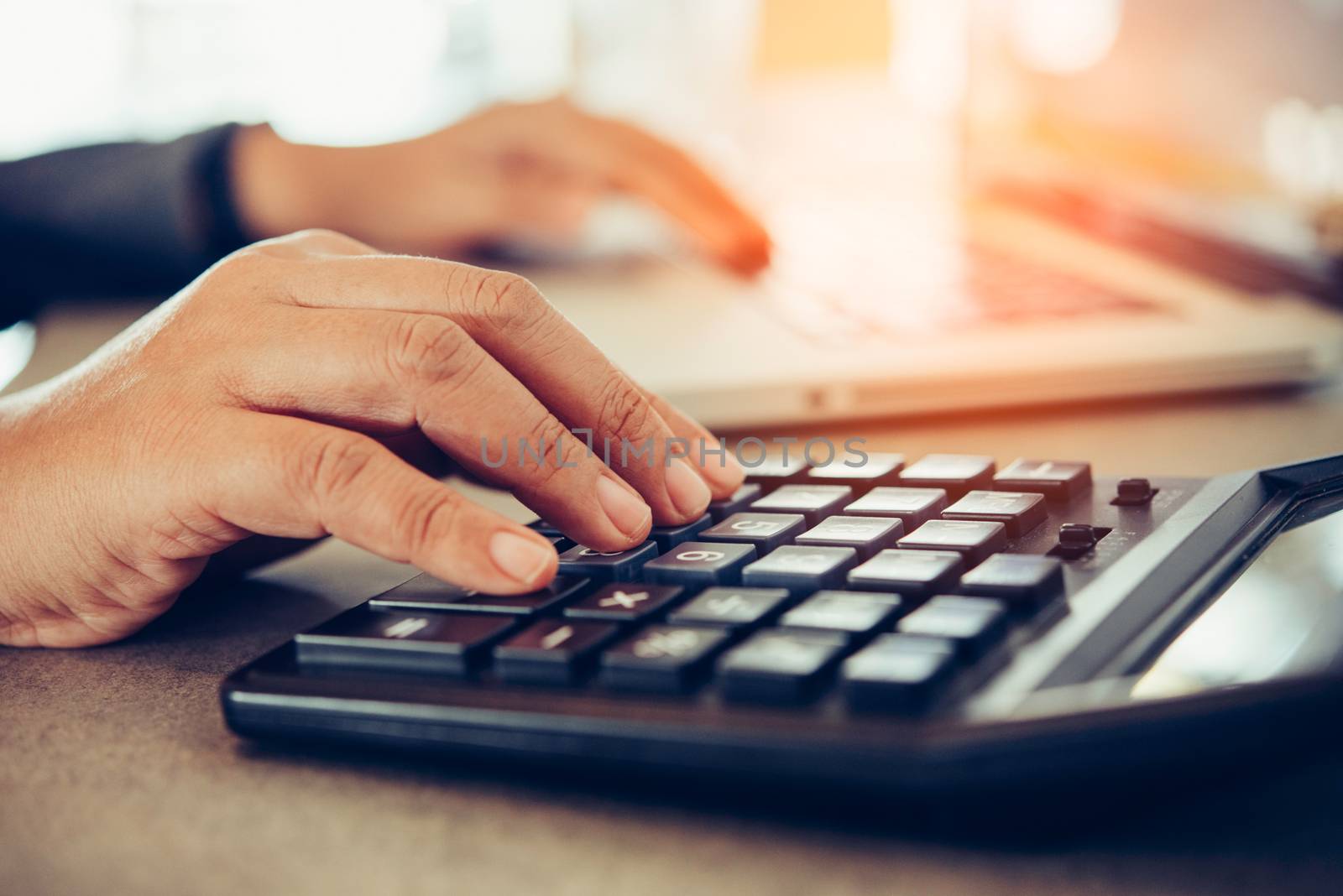 Business people are working on accounts in business analysis with graphs and documentation laptop in office 