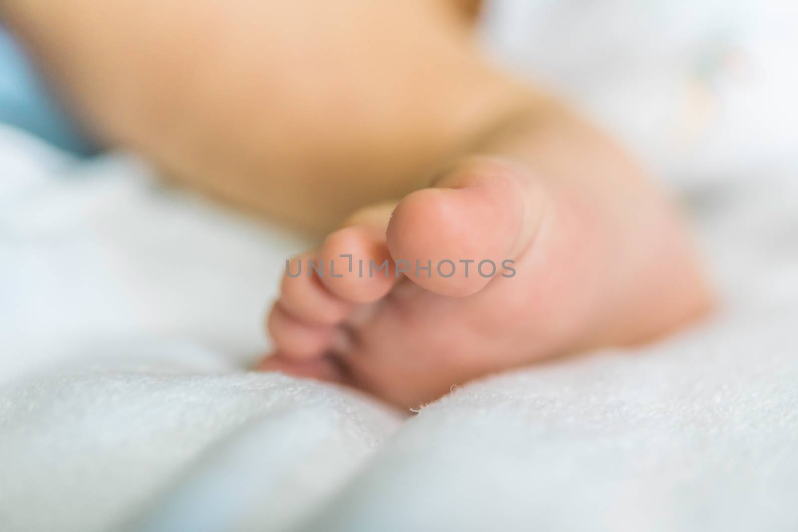 Baby's feet are on the couch. by photobyphotoboy