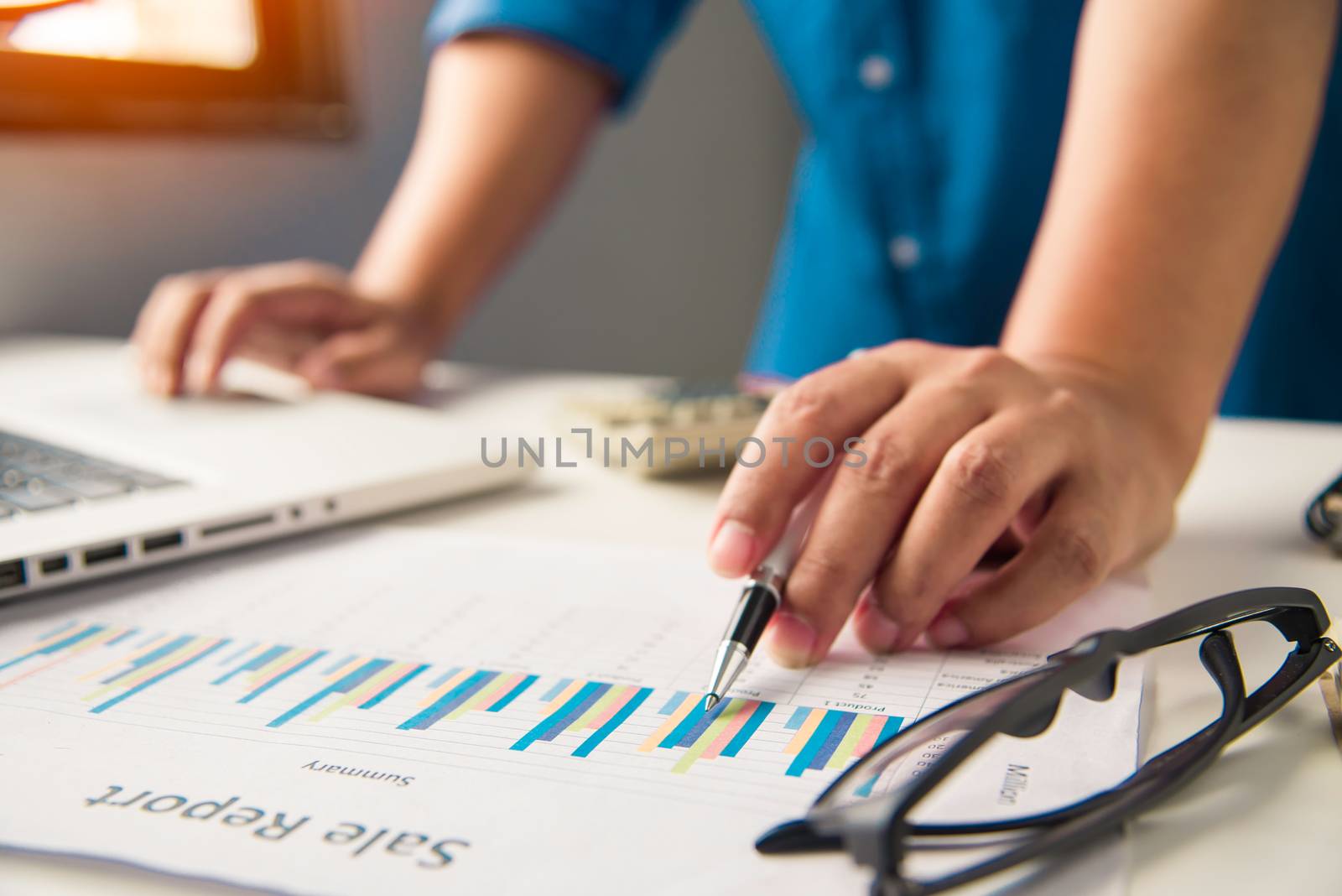 Business people are working on accounts in business analysis with graphs and documentation.