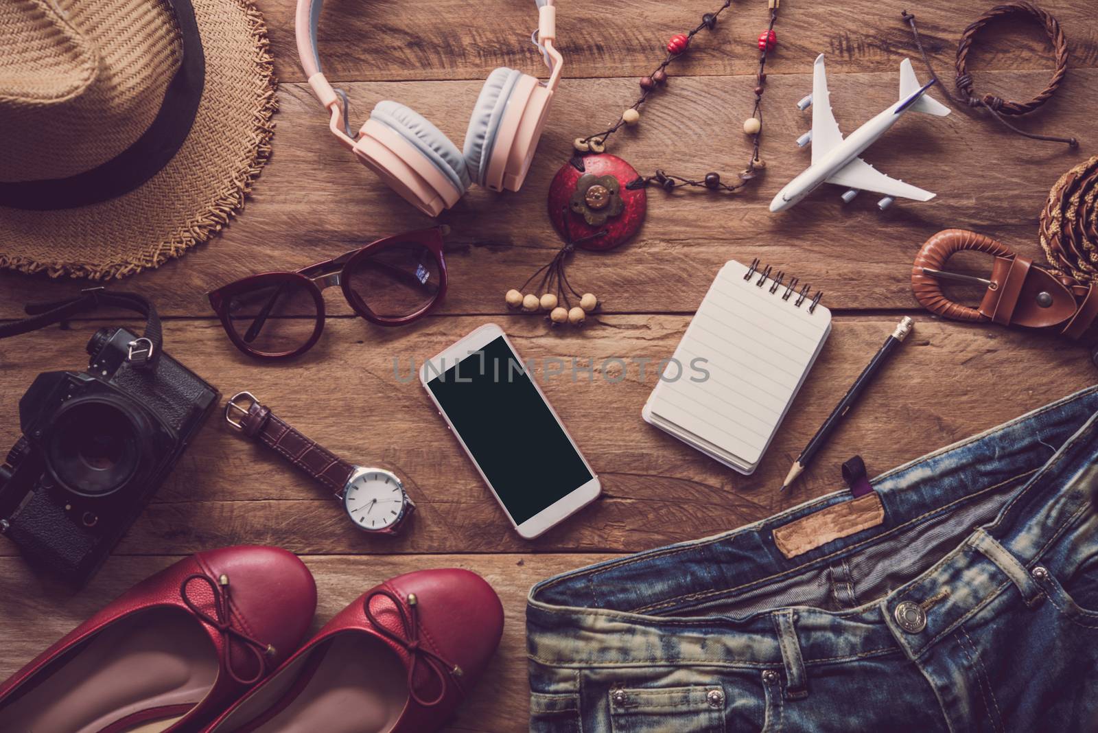 clothing for women, placed on a wooden floor for travel