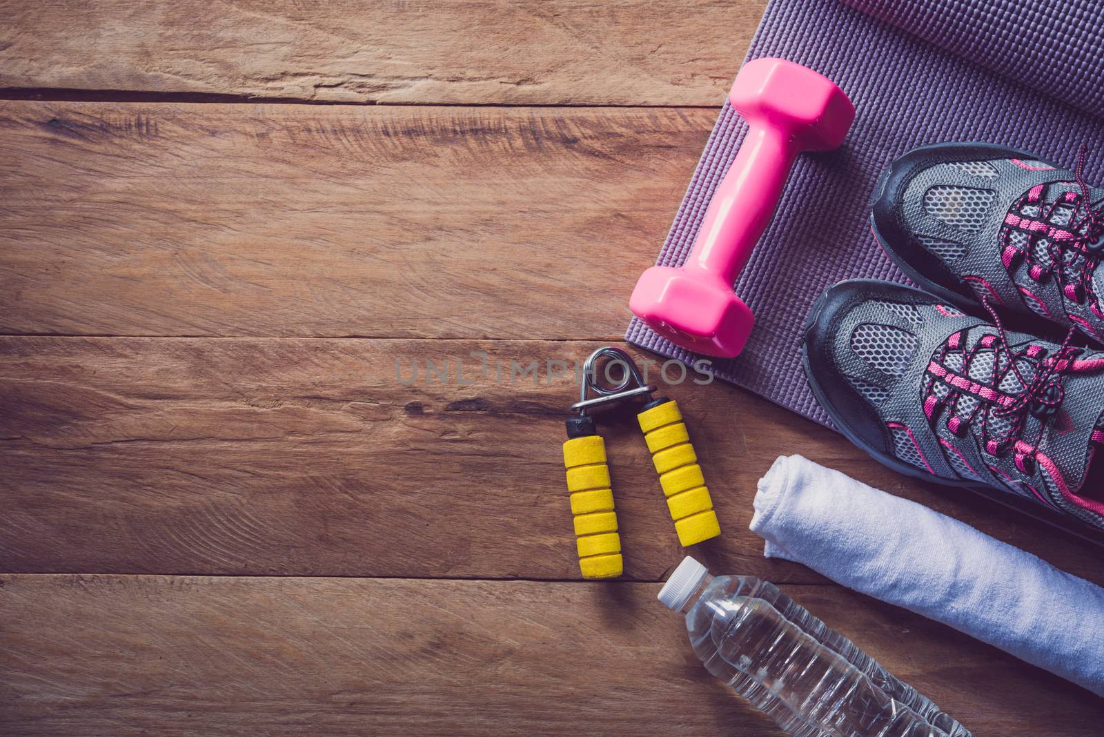 fitness concept with Exercise Equipment on wooden background.