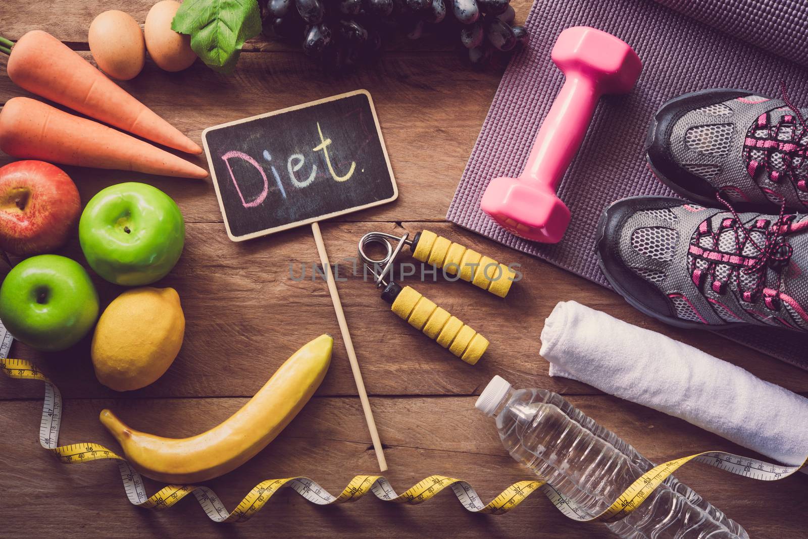 The concept of diet for weight loss - Exercise Equipment and word  " diet " in wooden place