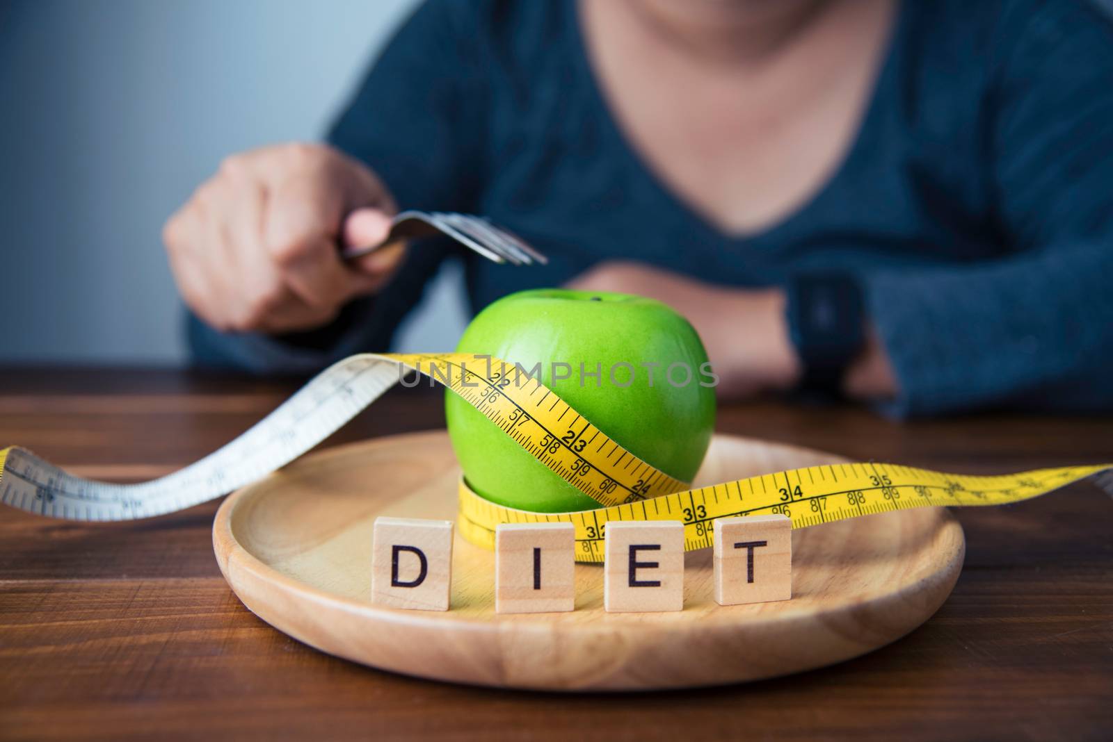 Young women are deciding to eat fruit to help them lose weight.- concept diet