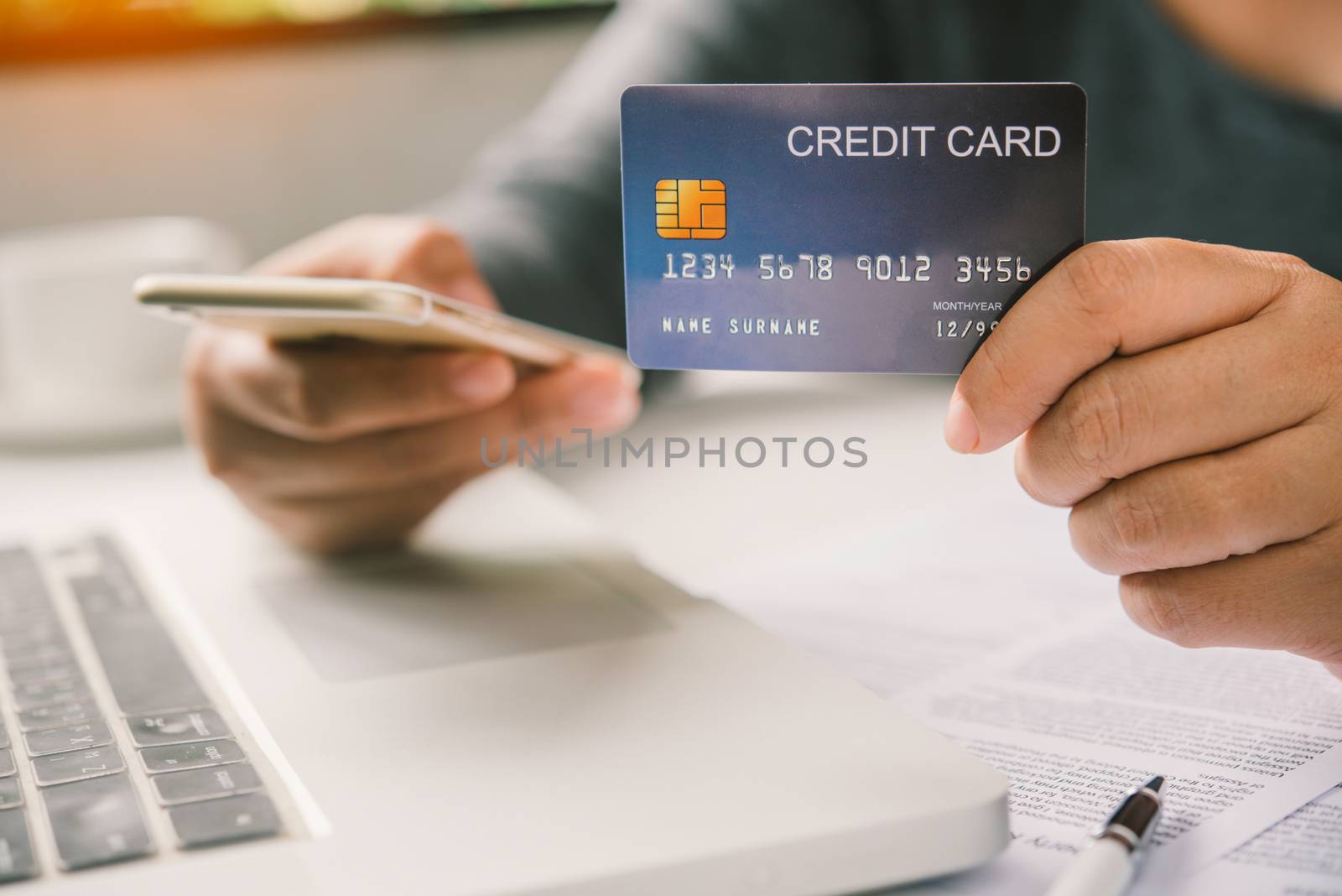Online payment, hands holding a credit card and using smart phone for online shopping,
Online financial transactions