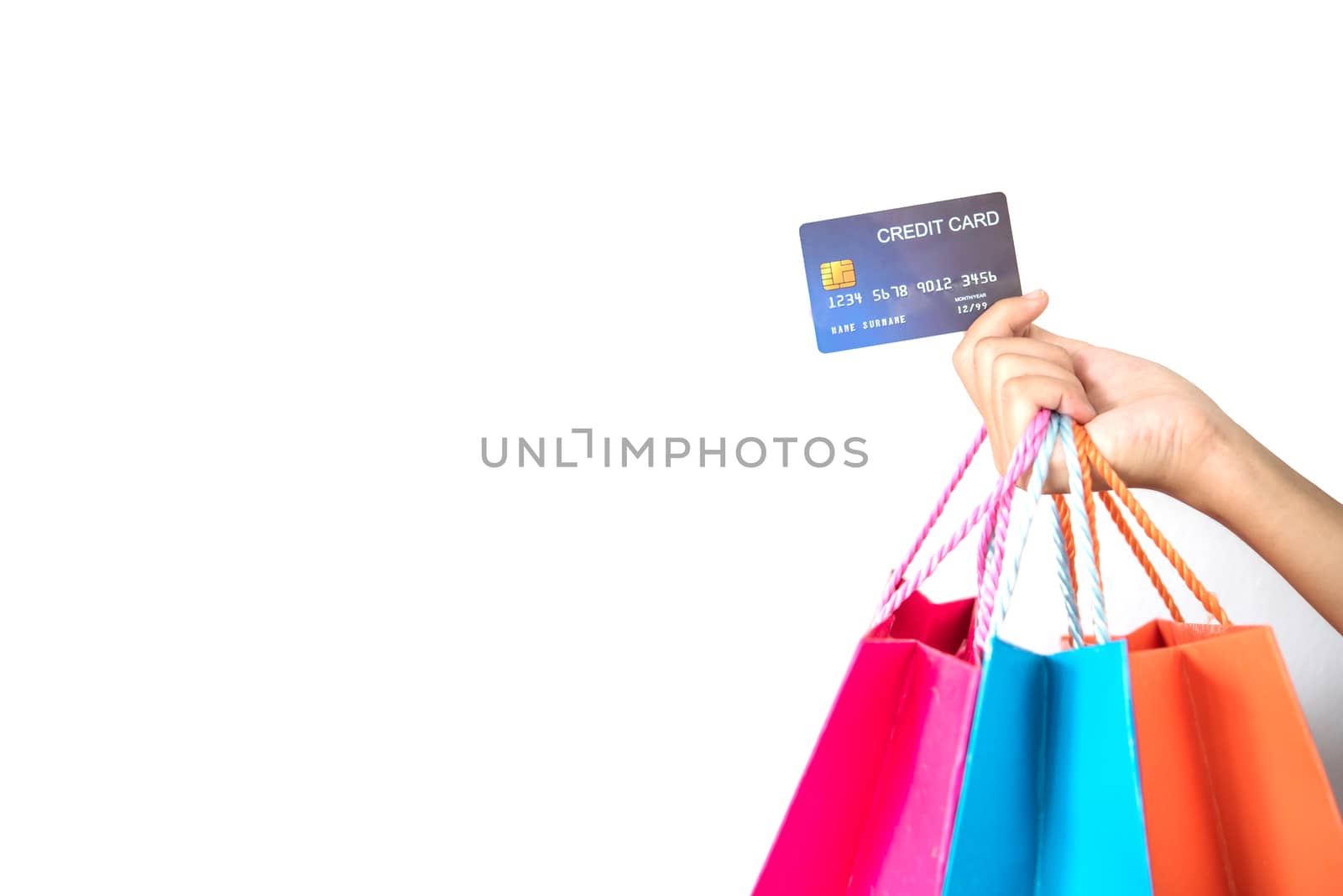 Woman hand with shopping bags and credit card on white background