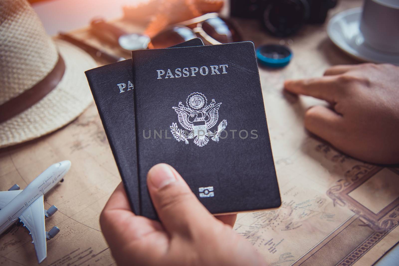Travelers are planning a trip by searching the route on the map and preparing the necessary travel 
