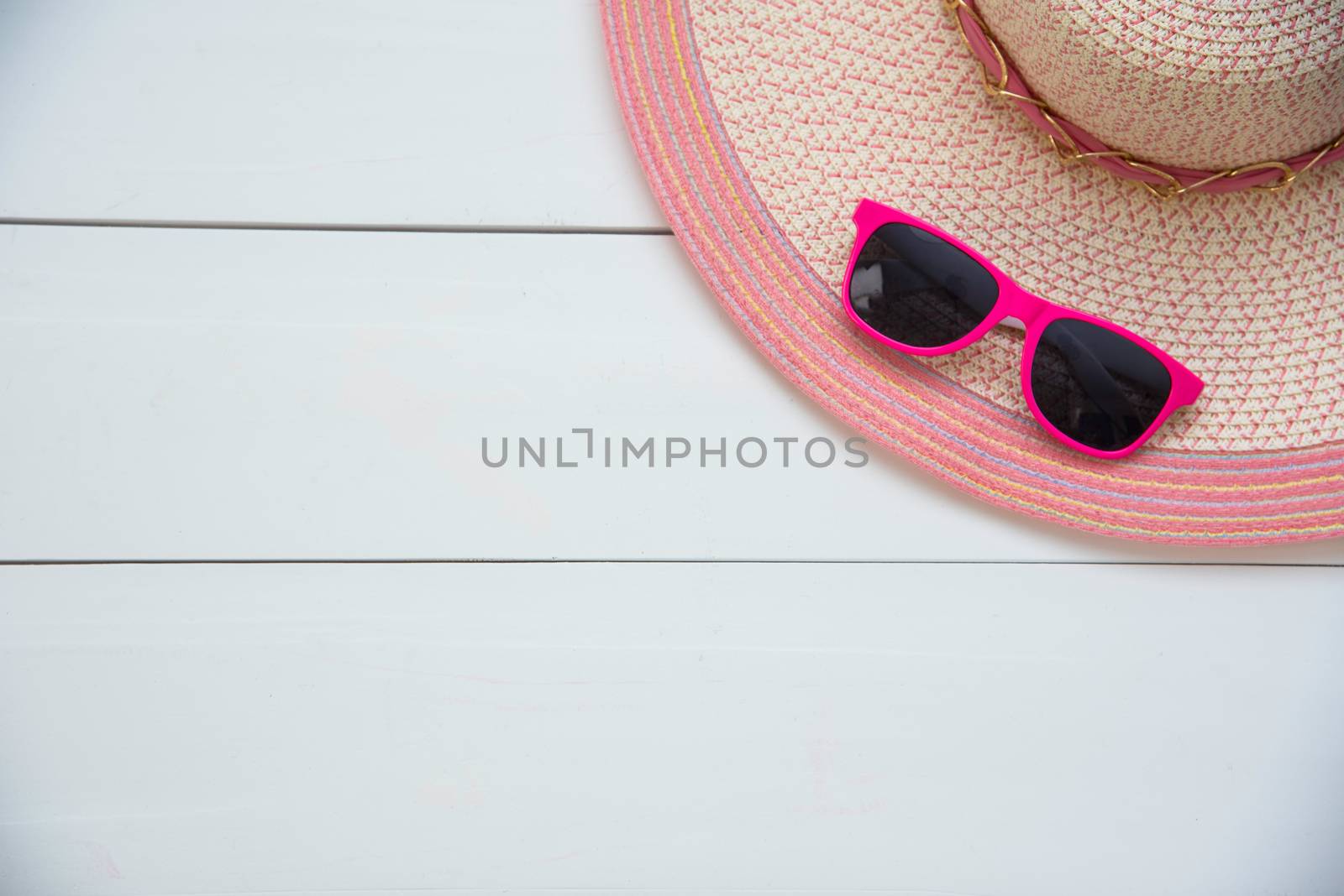 Hat and red sunglasses fashion on the pink wood for women
