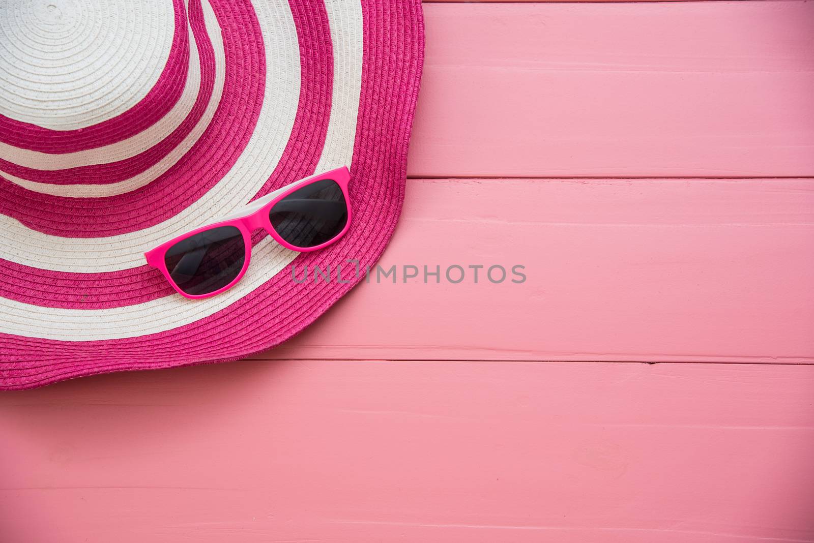 Hat and red sunglasses fashion on the pink wood for women by photobyphotoboy