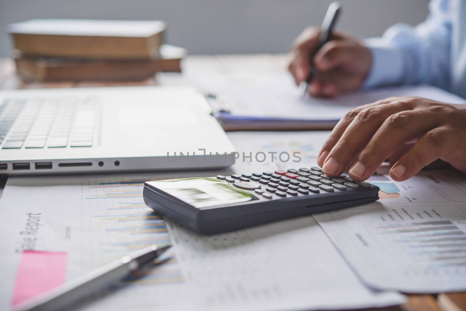 people are working with a calculator and laptop. in office business concept