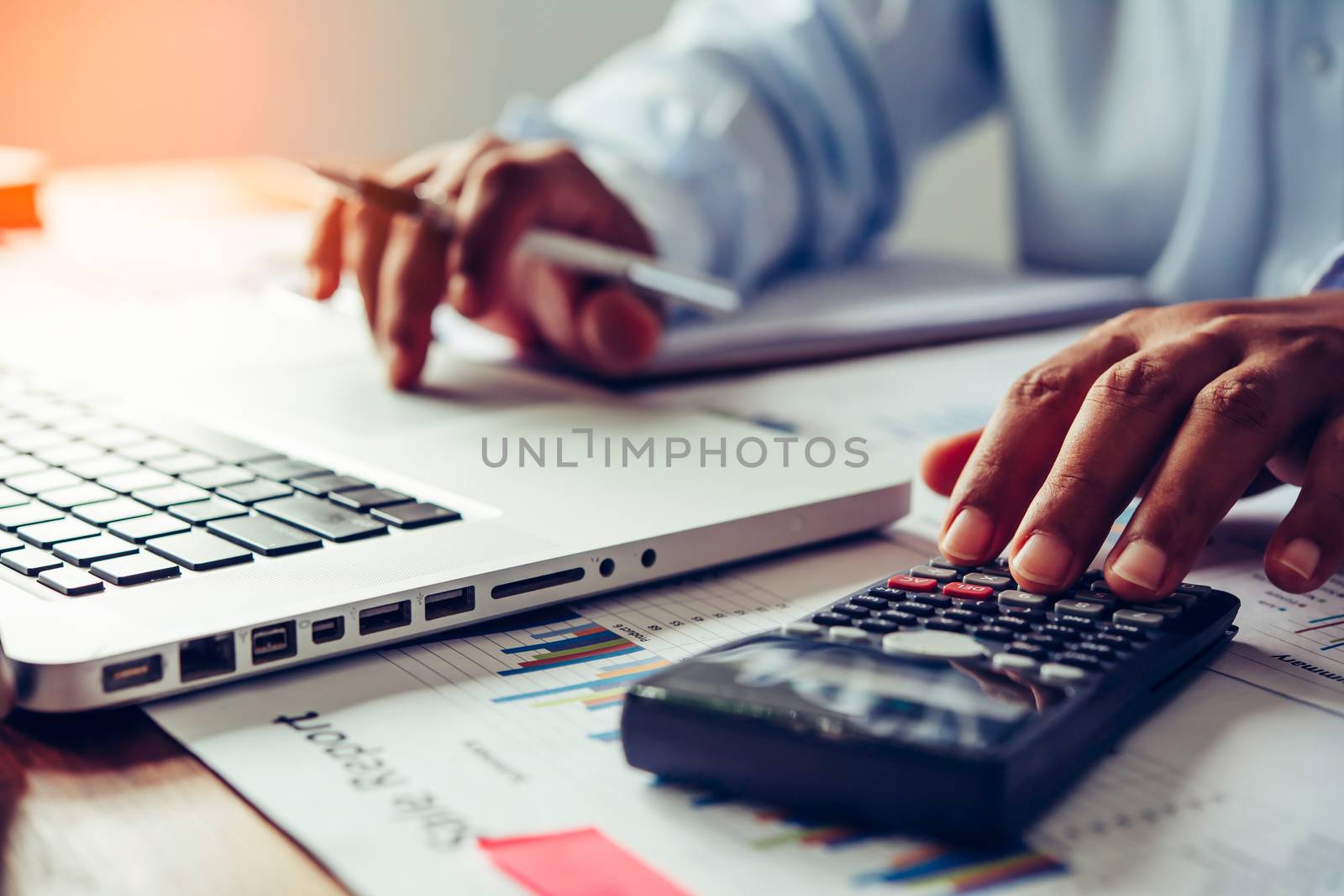 people are working with a calculator and laptop. in office business concept