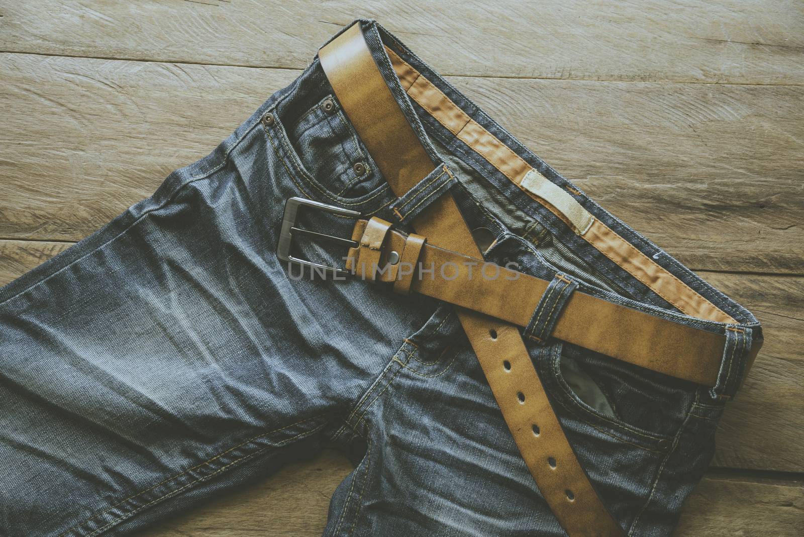 Jeans for men on a wooden floor