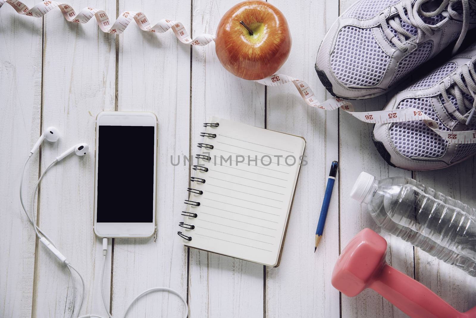 fitness concept with Exercise Equipment on white wooden background.