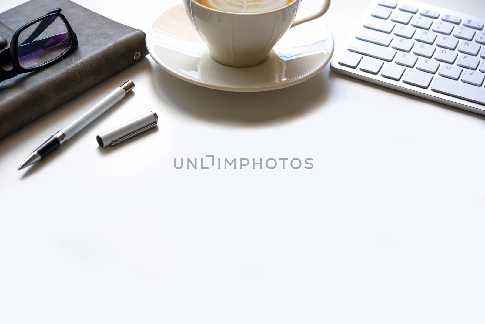copy space, working desk with laptop,cell phone,notebook pencil and coffee on white background