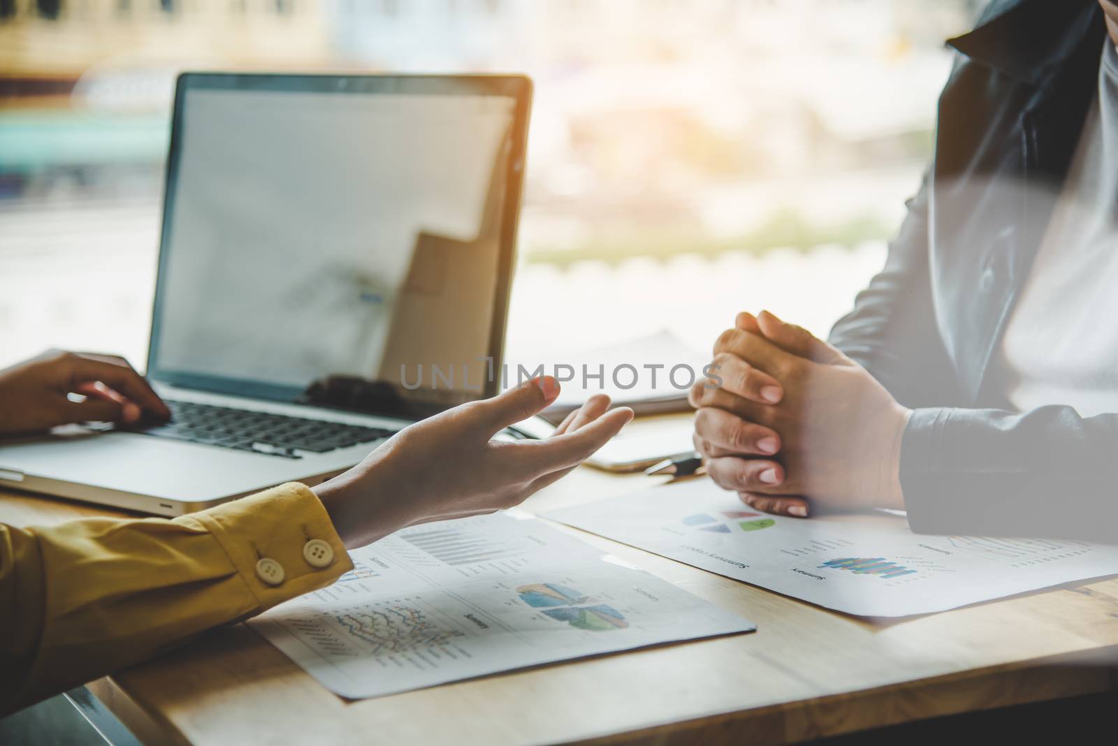 Business team is working on accounting documents and team work together to present the work and help solve the problem.