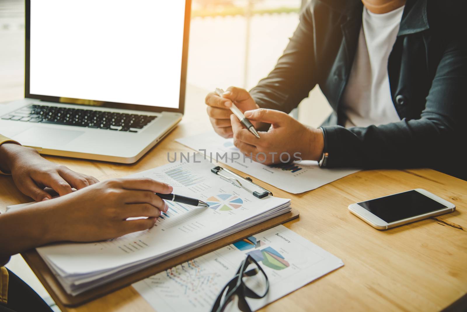 Business team is working on accounting documents and team work together to present the work and help solve the problem.