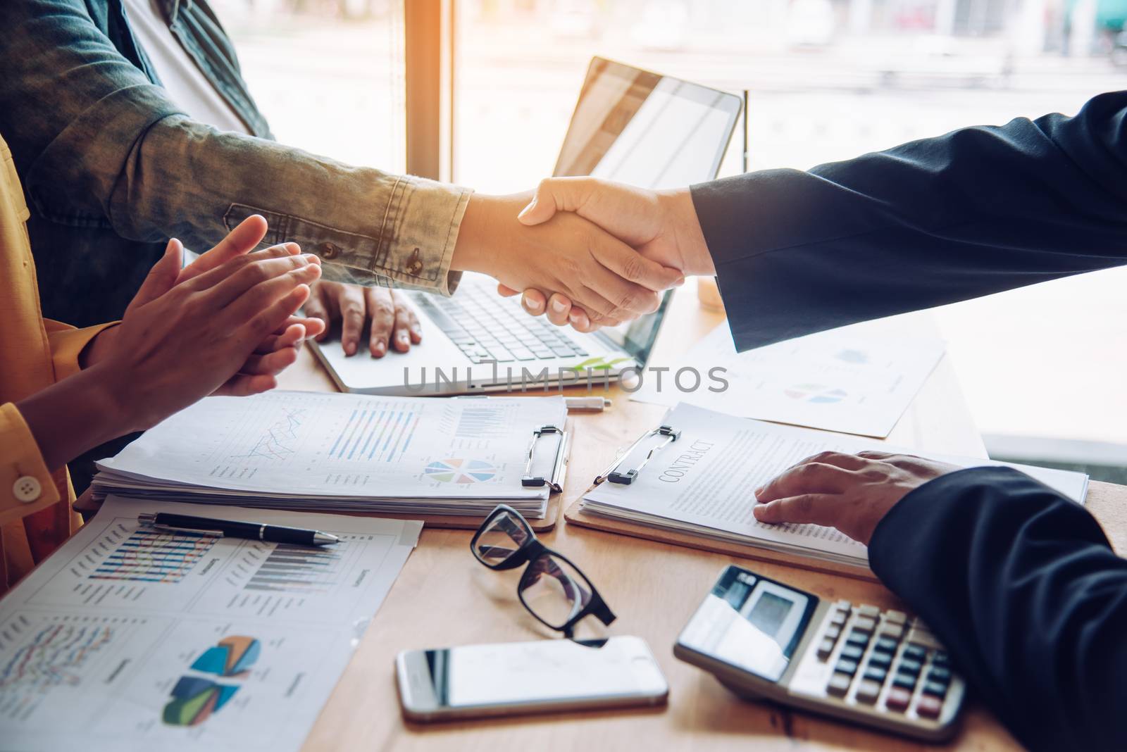 Handshake between joint venture businessmen after good management and have good concept 