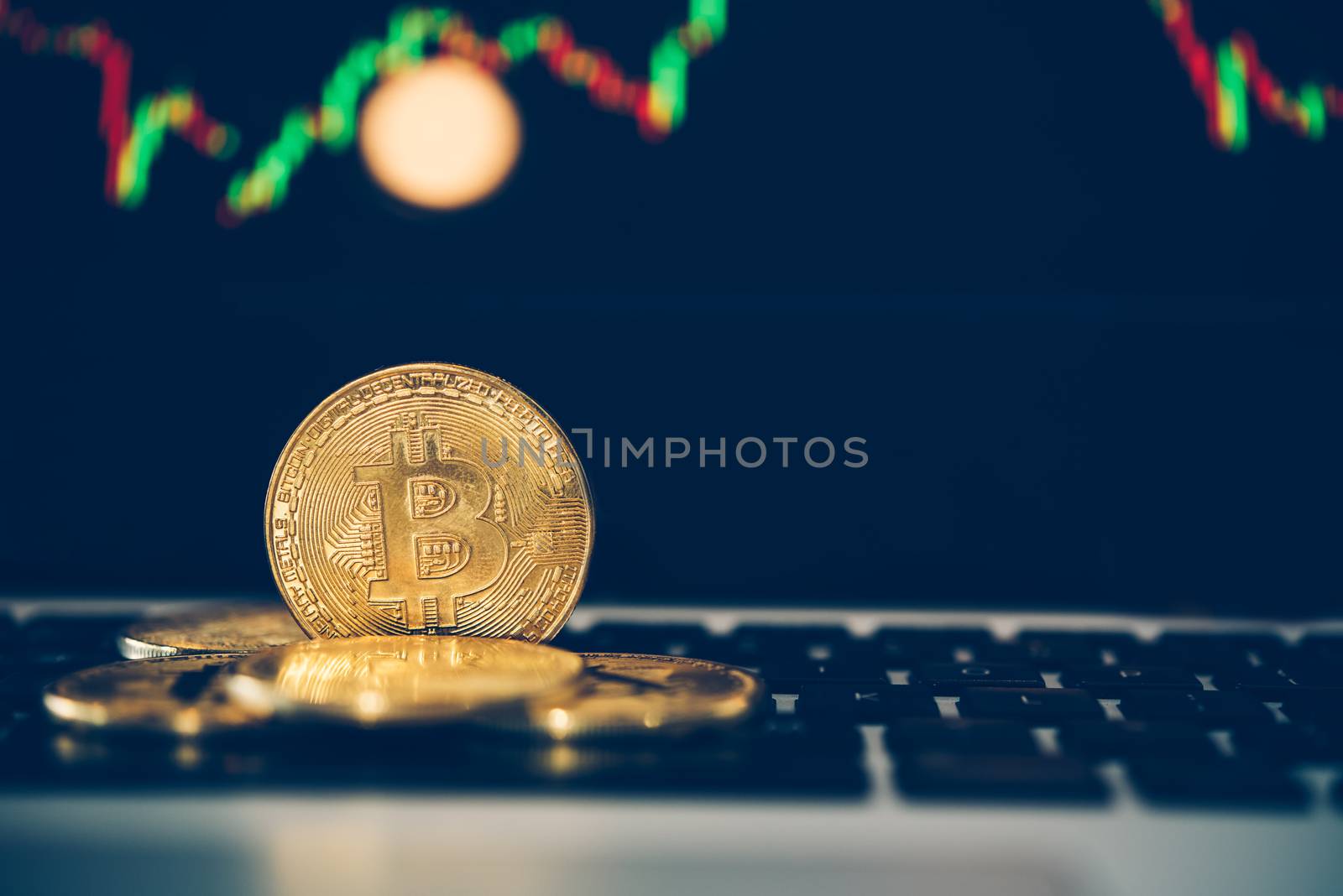Bitcoin gold coins coin and defocused chart background