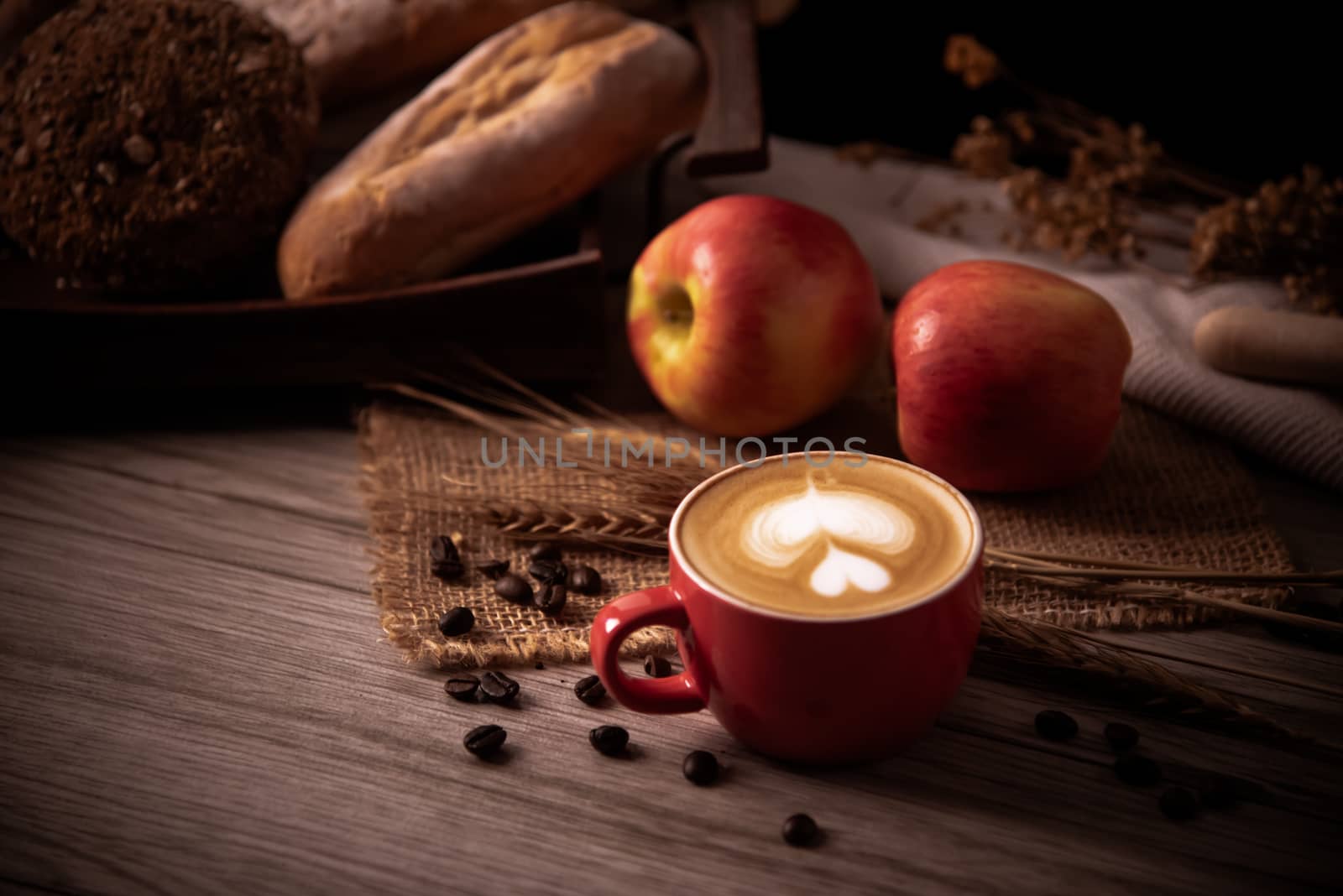 Red coffee glass rests on wood floor. concept still life