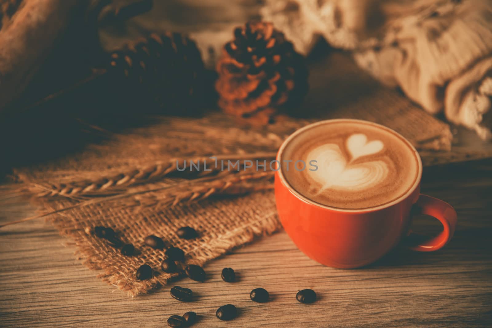 Red coffee glass rests on wood floor. concept still life