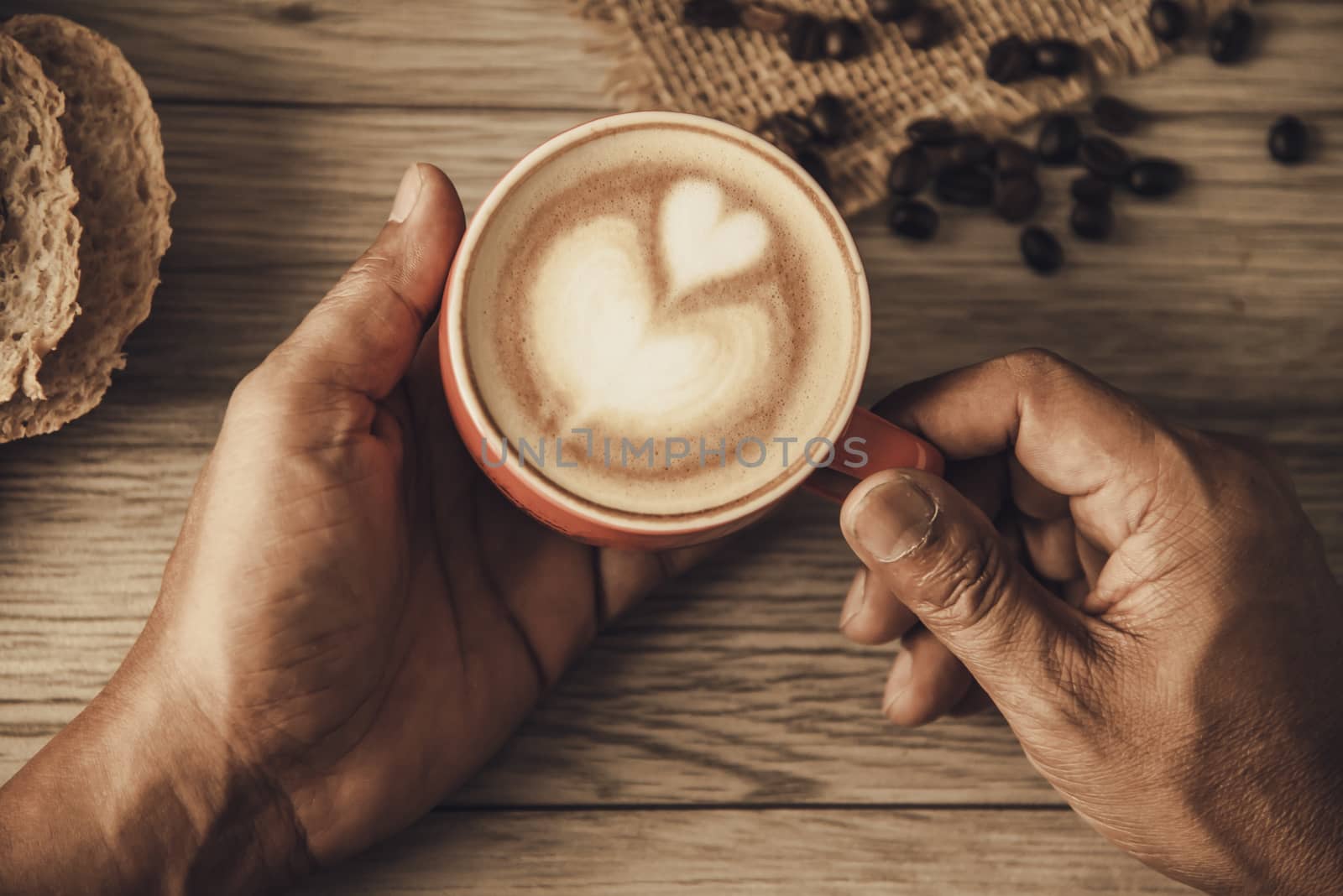 Hand is holding a red cup of coffee. concept still life
