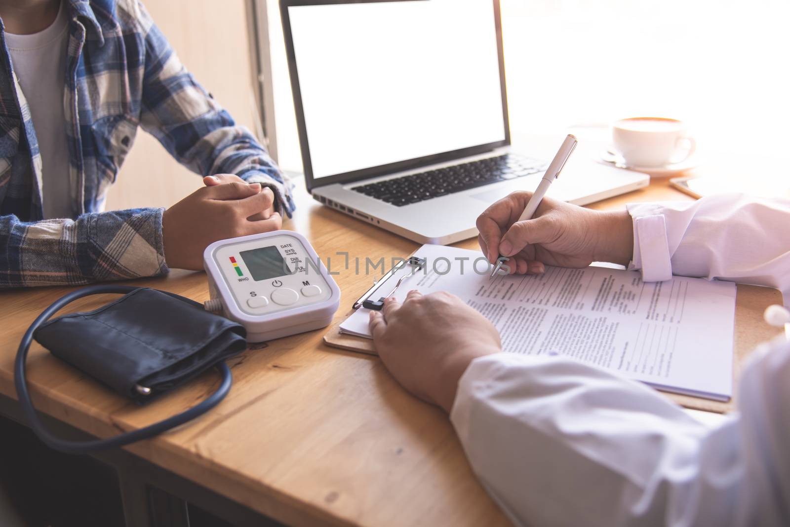 The doctor is discussing with the patient after a physical examination of the results and treatment guidelines.