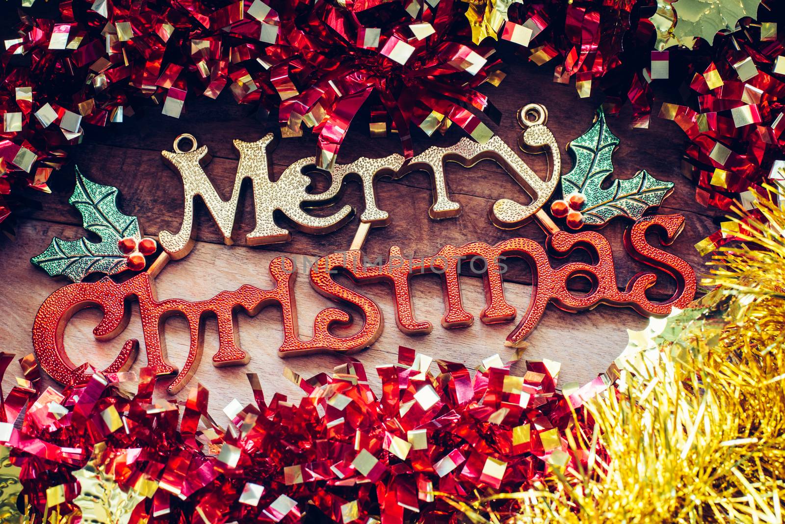 Christmas decorations and "Merry christmas" greetings on a wood background.