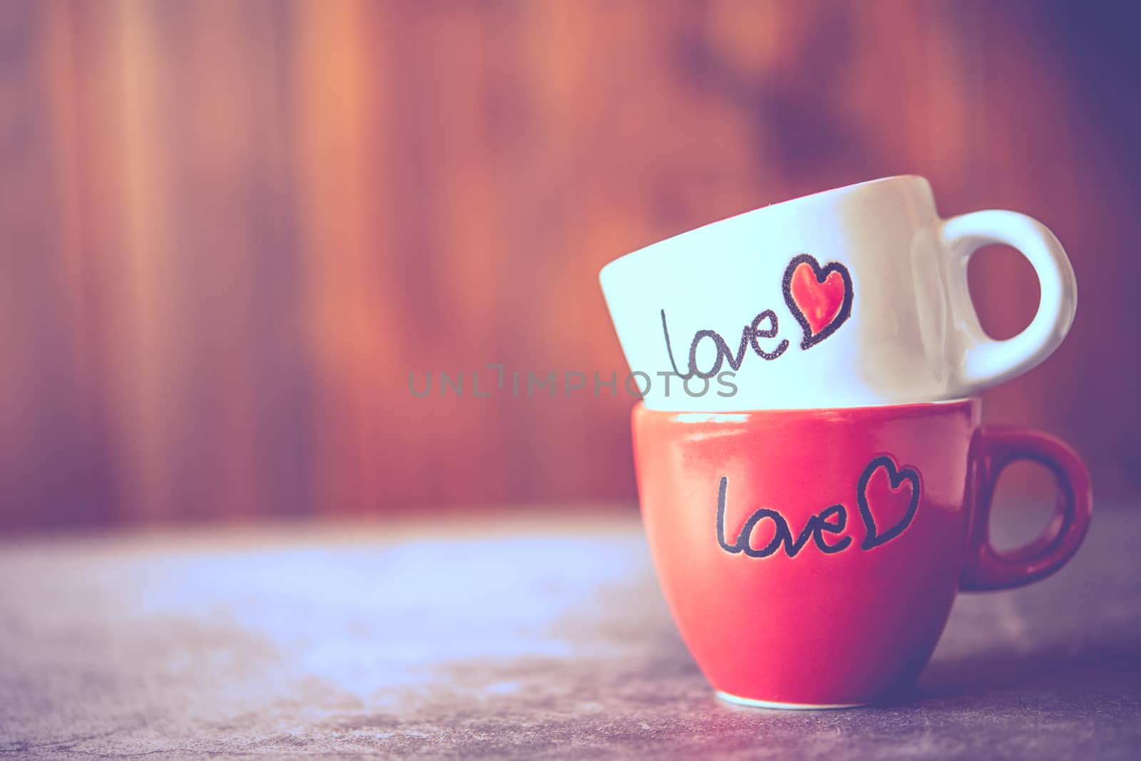 Coffee cup with "love" stacked on the floor.