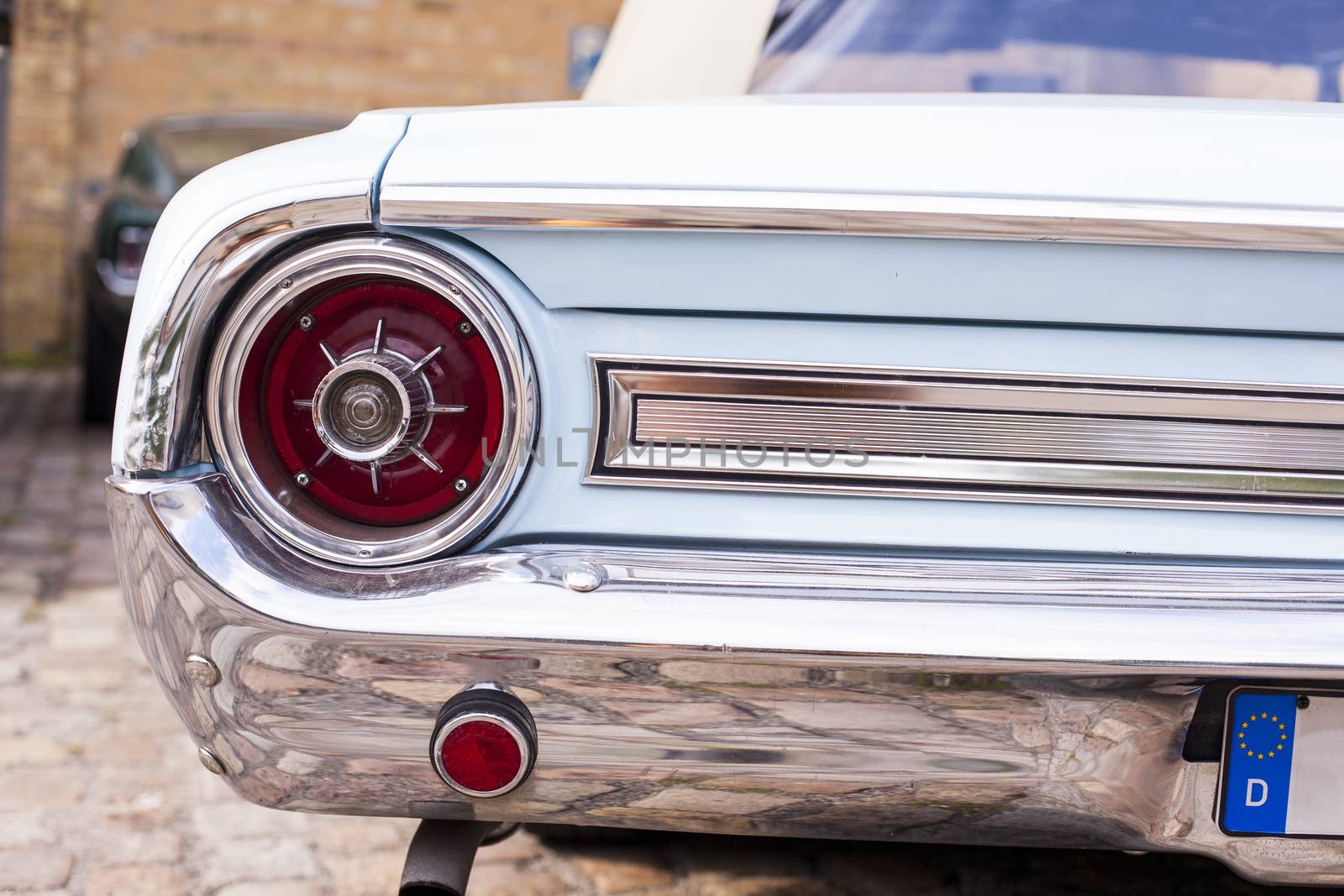 Close-up of headlights of luxurious vintage vehicle by Vanzyst