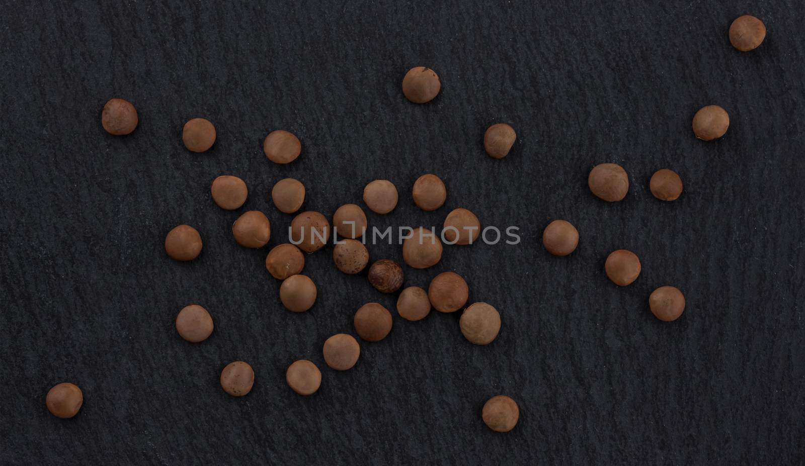 Lentils grain on black background, top view