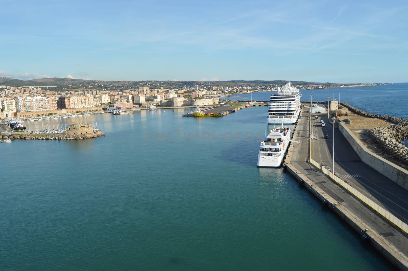 View of stone and concrete breakwaters along the pier, cruise liners and a panorama of the port of Civitavecchia, October 7, 2018 by claire_lucia