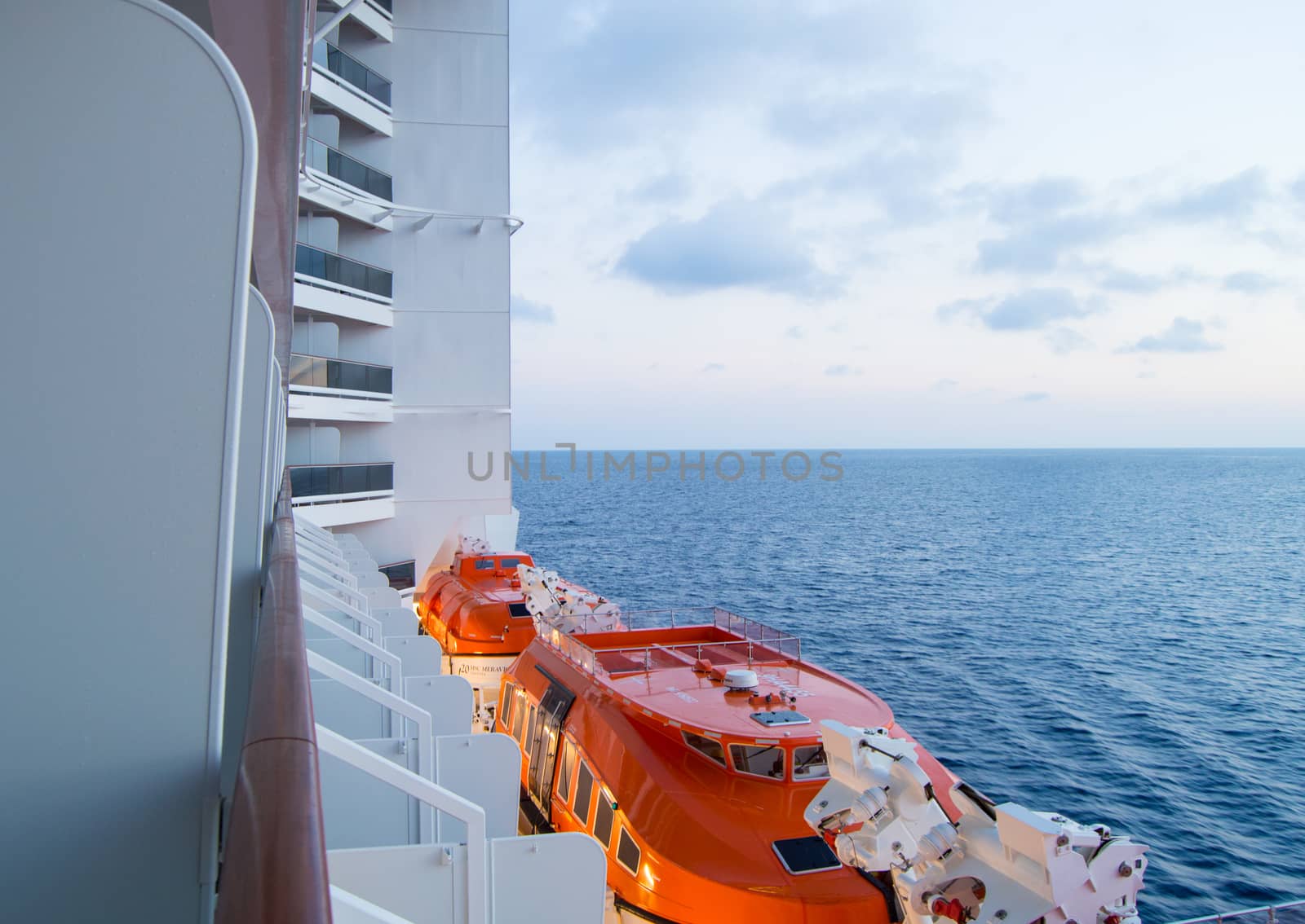 Sunset on the Mediterranean sea, a beautiful view from the cruise ship, visible lifeboats by claire_lucia