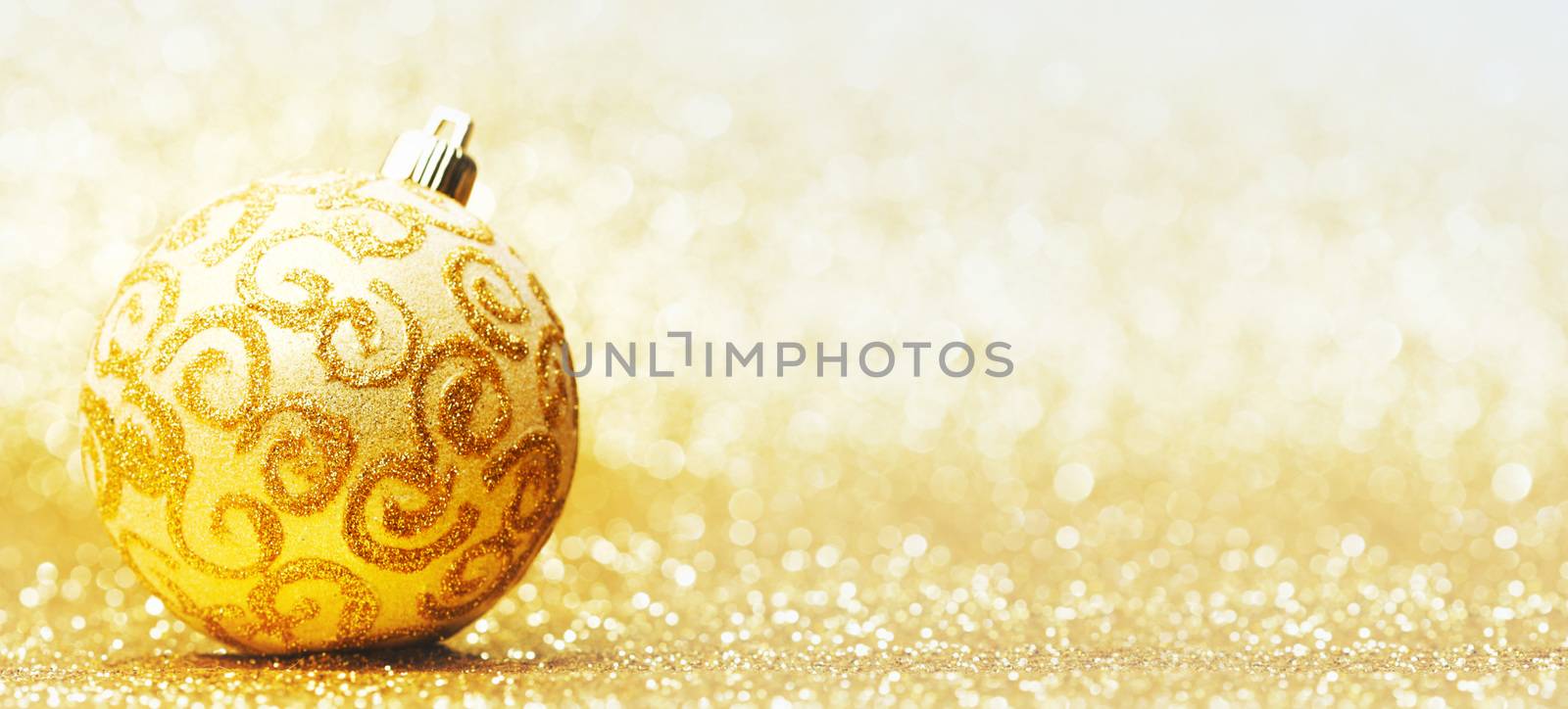Decorative christmas ball on golden background