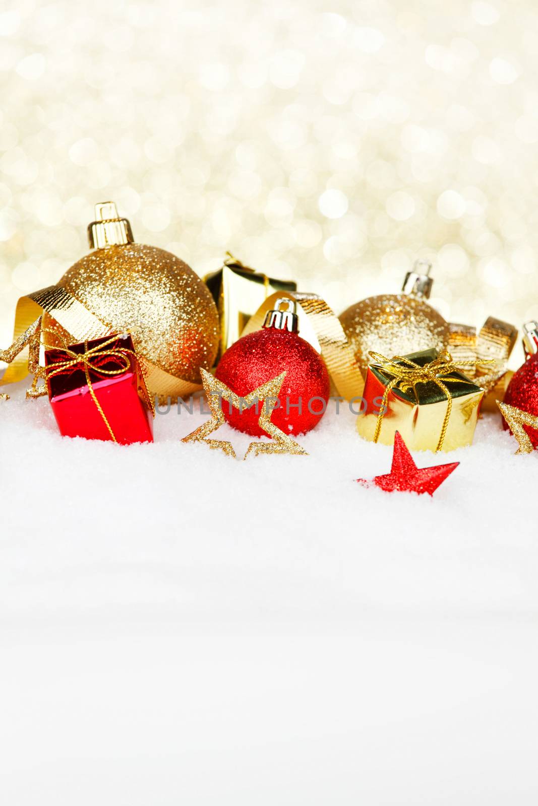 Red and golden christmas balls and decoration on snow