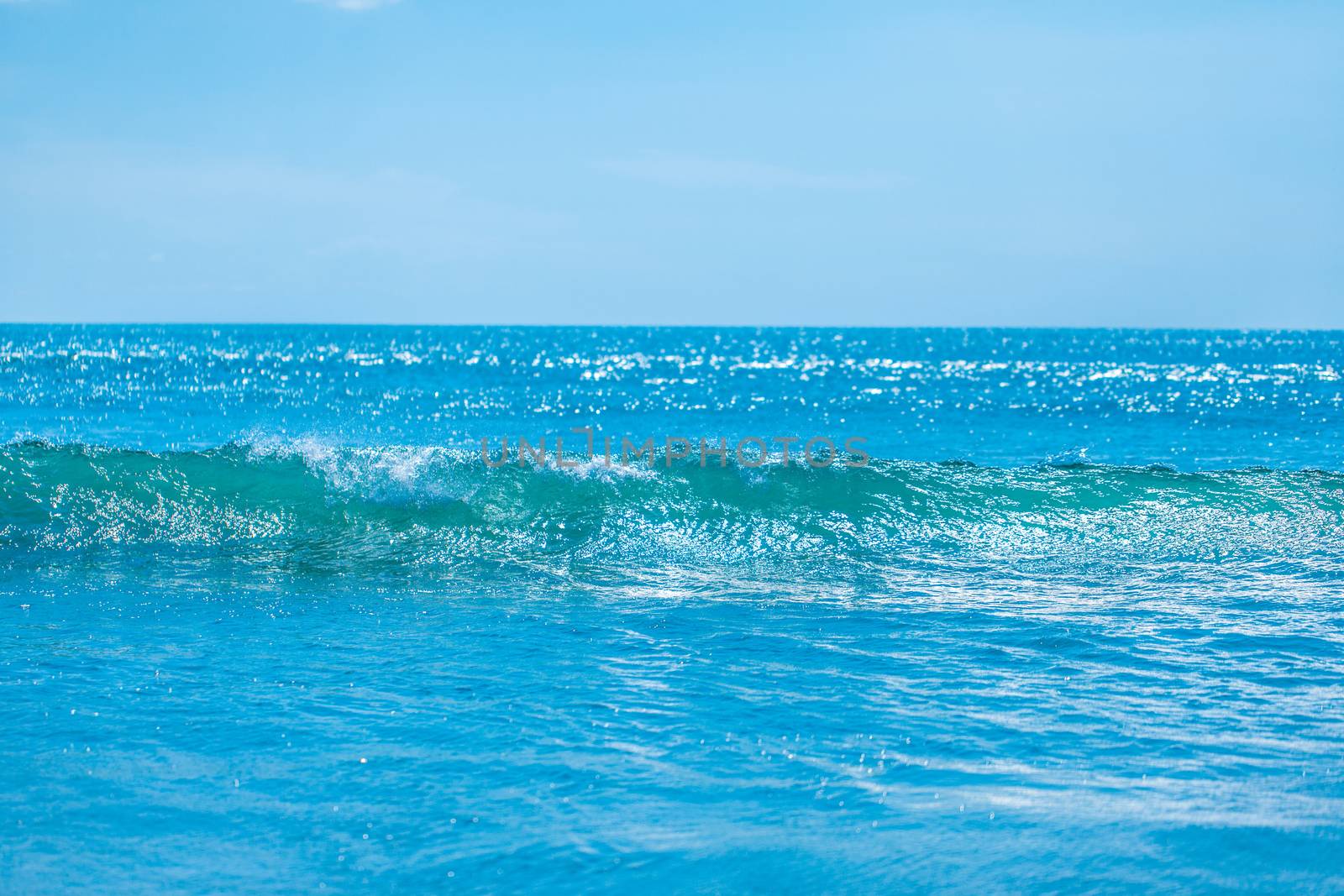 Blue tropical sea waves and clear sky background