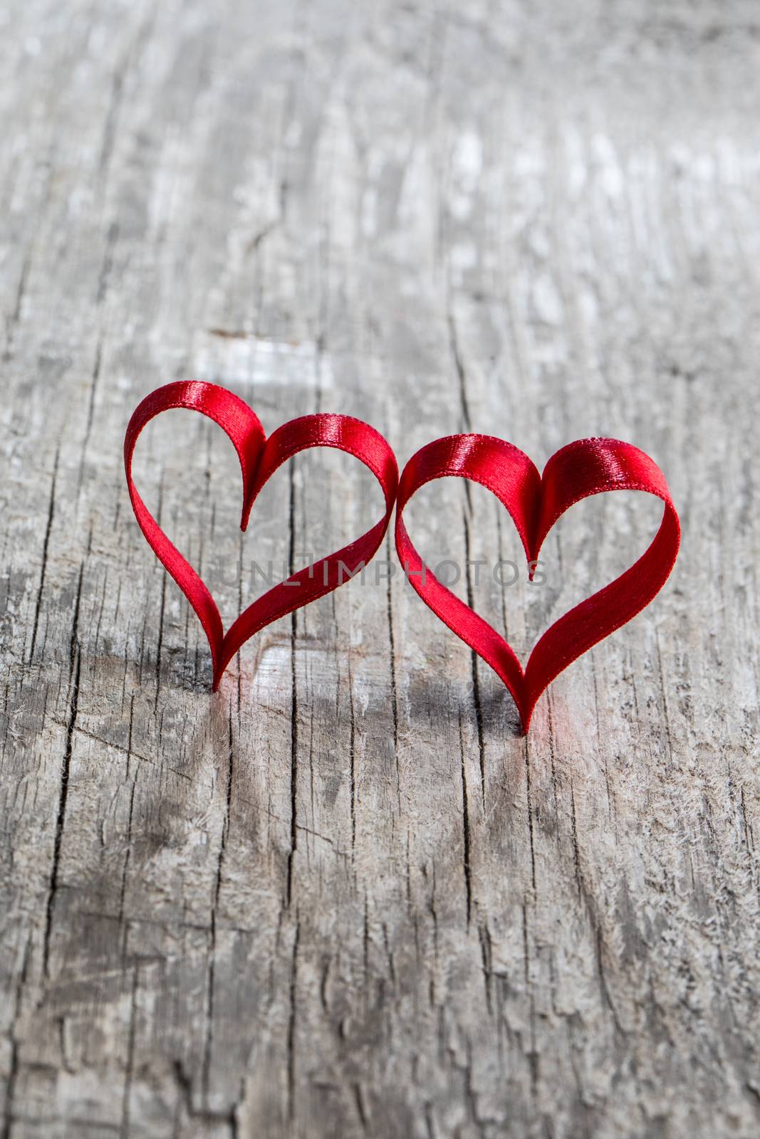 Two red ribbon hearts on wooden backround, Valentine day concept