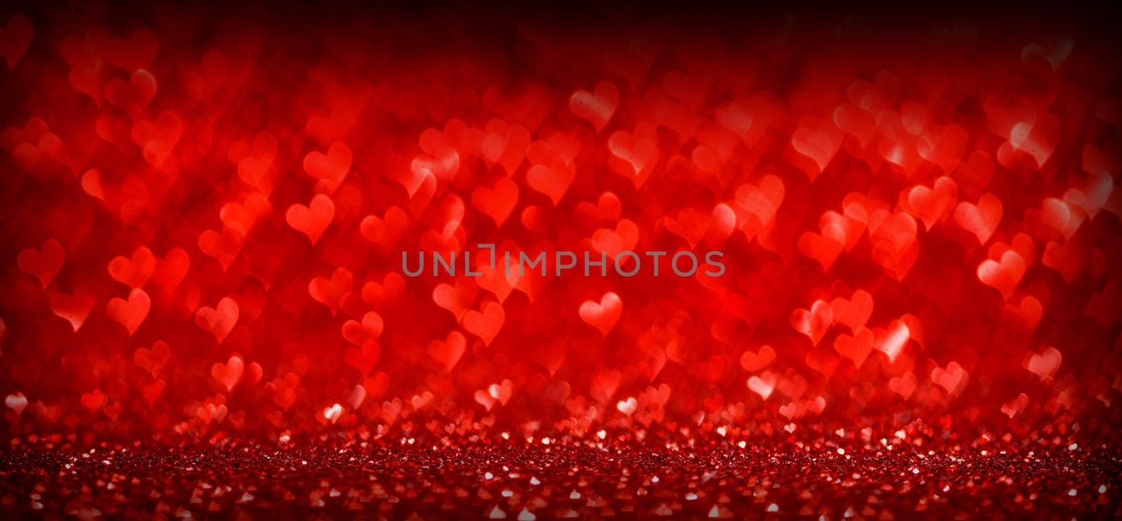 Red glowing bokeh hearts background for Valentines day