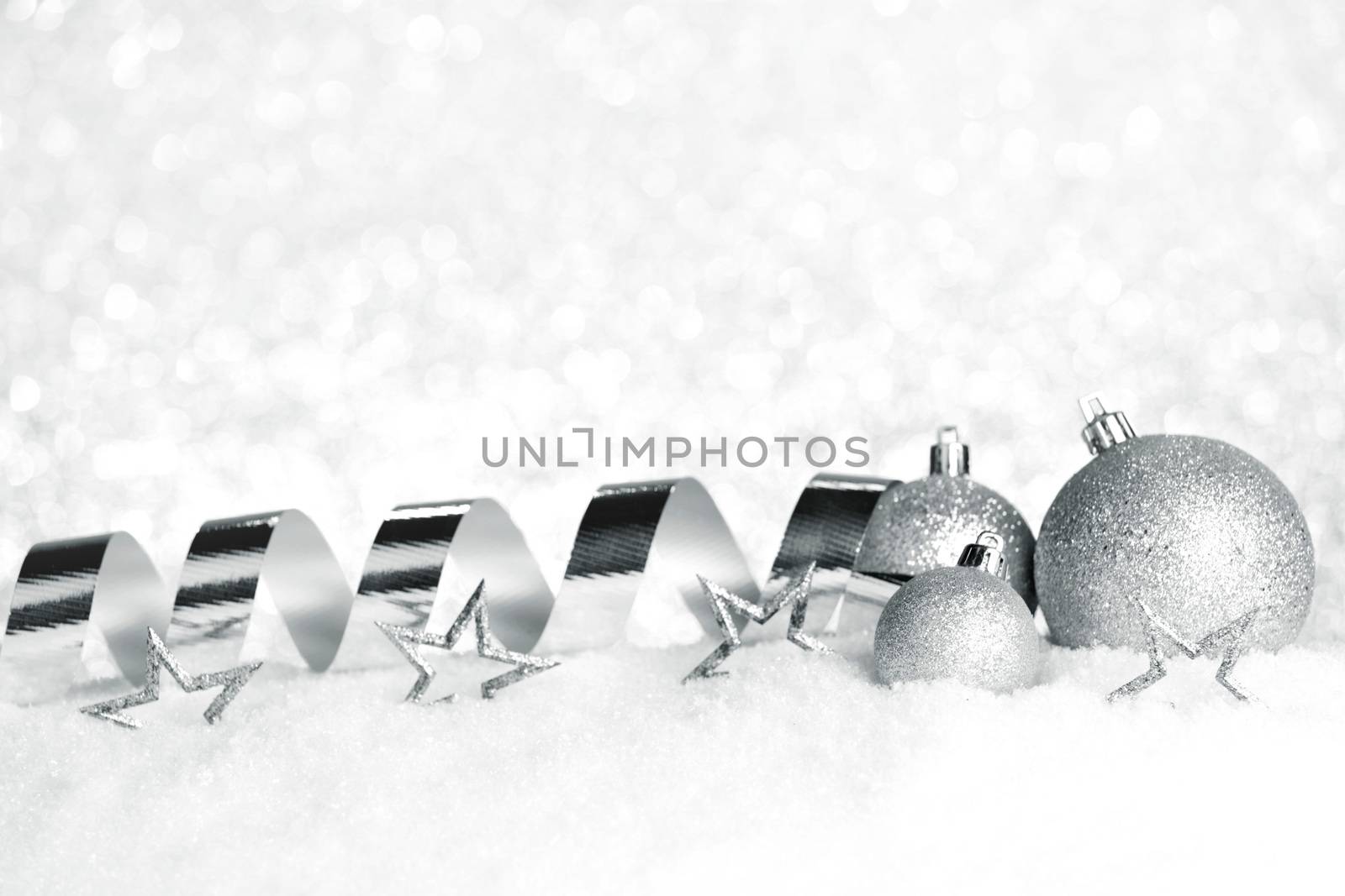 Silver Christmas decorations on snow close-up