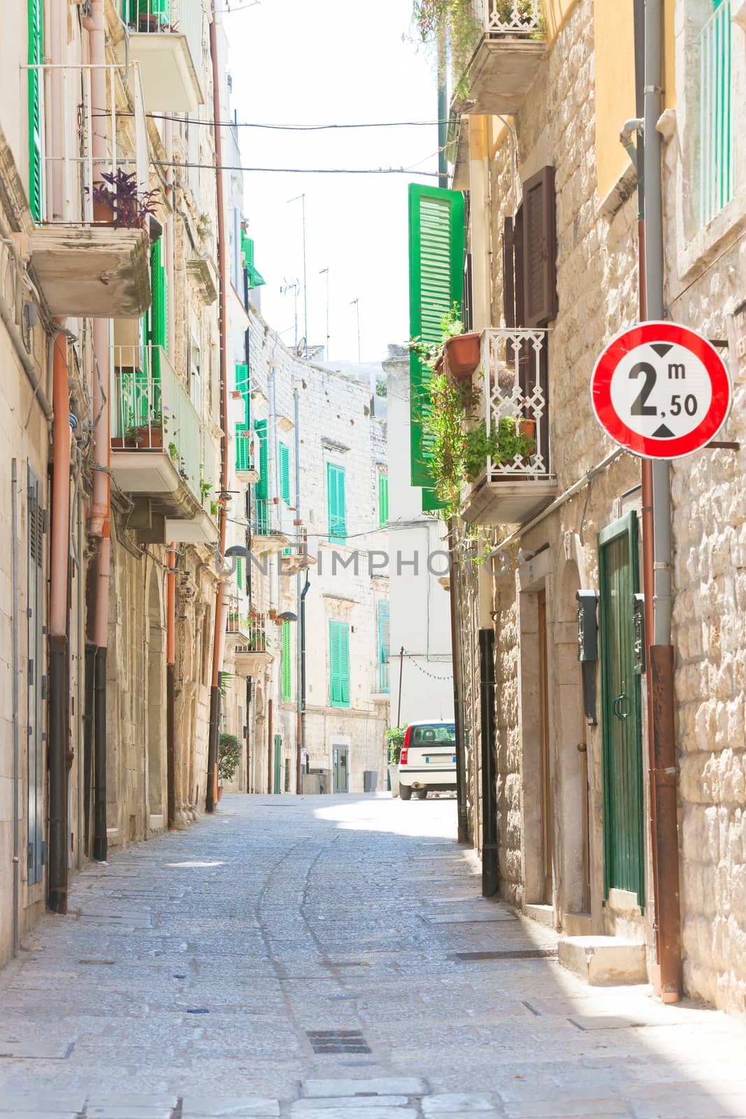 Molfetta, Apulia - Walking through an old alleyway in Molfetta by tagstiles.com