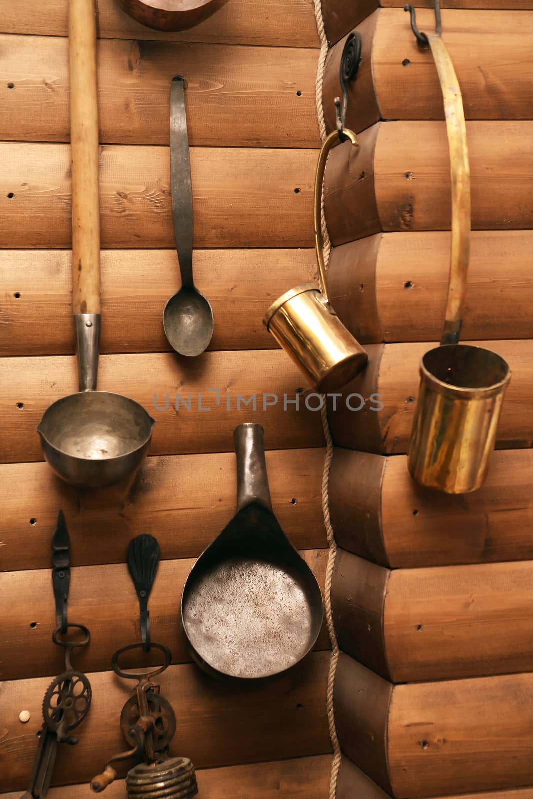 Set of old farm utensil hanging on wooden wall