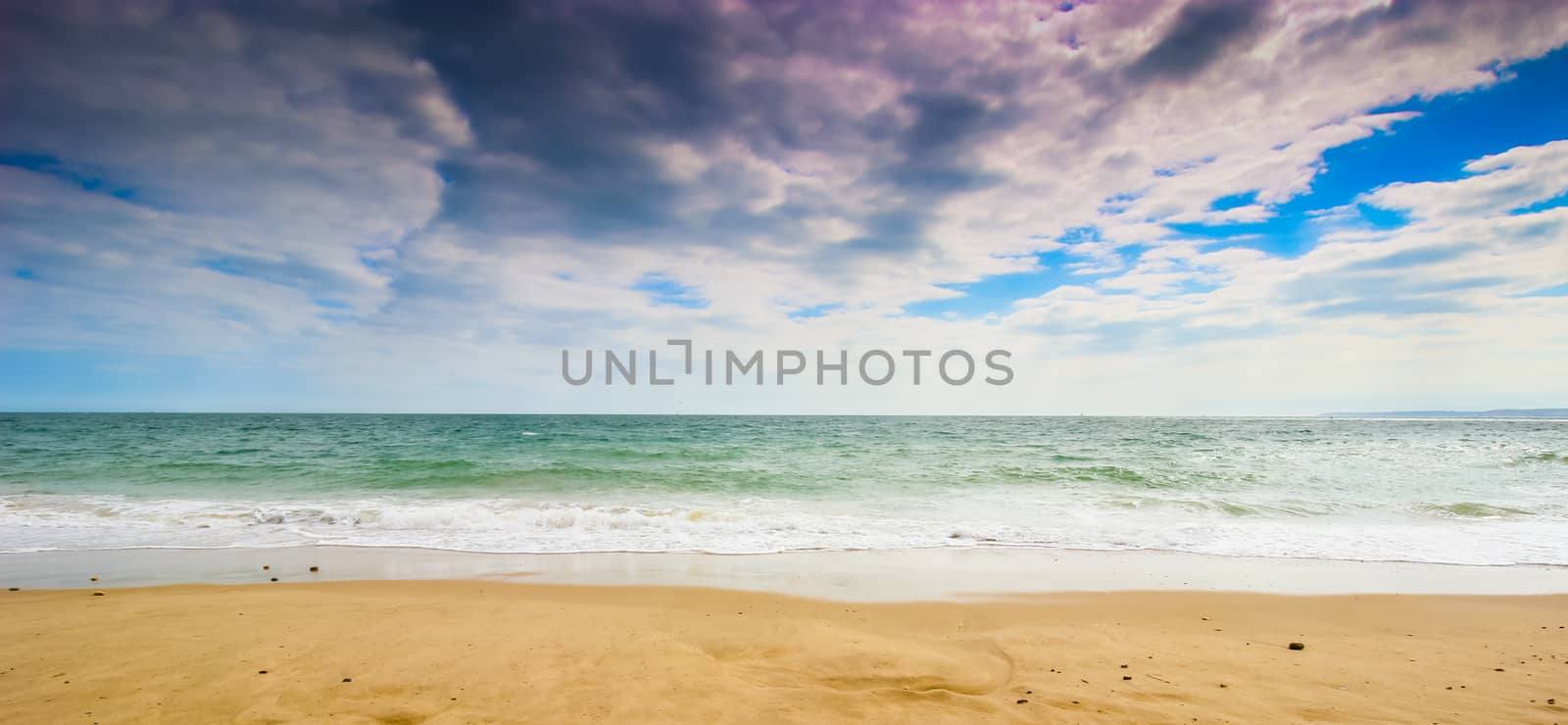 A wide angle landscape shot of beach in the sun